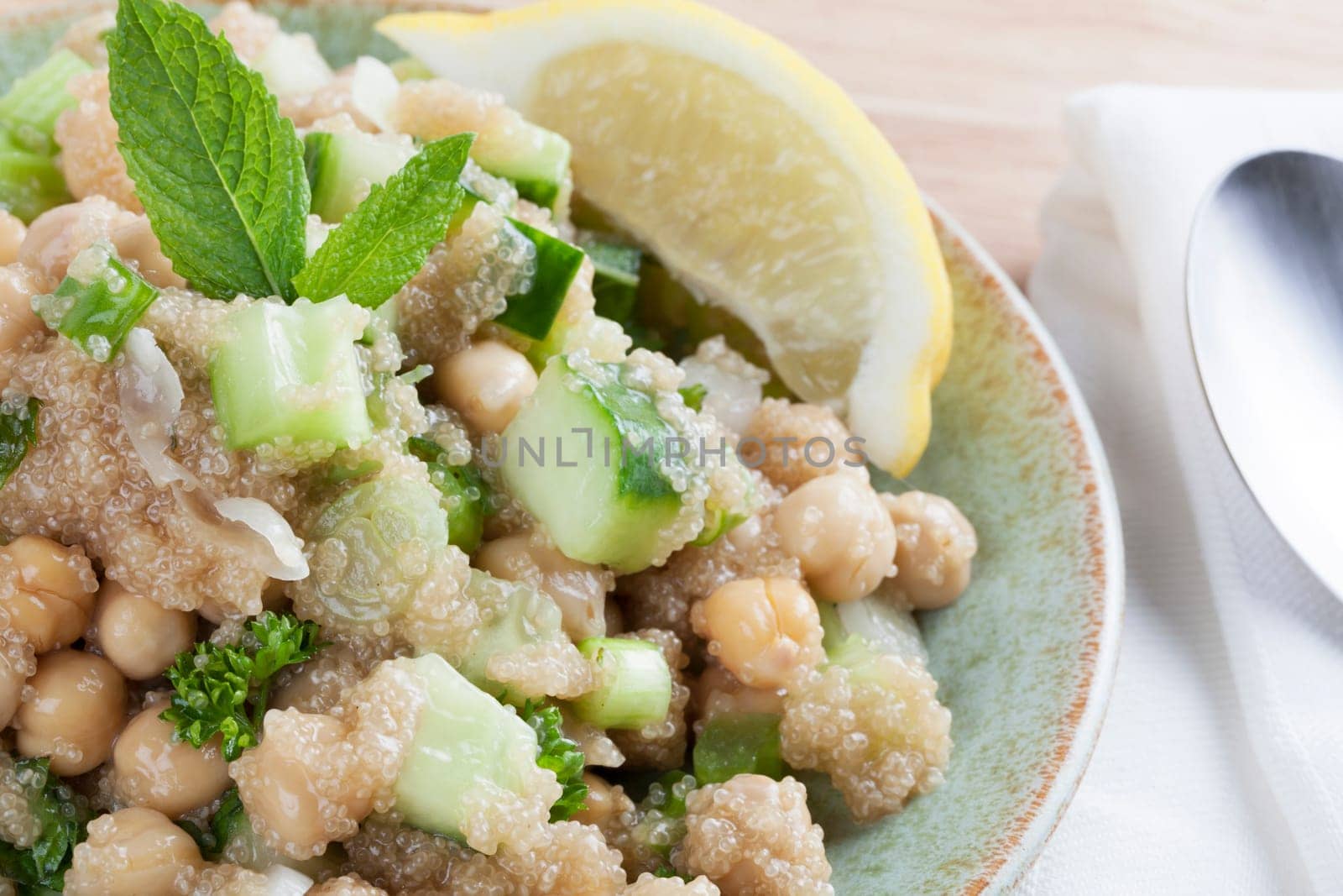 Cooked amaranth seeds with cucumber chickpeas and mint in a tabouli style vegan salad.