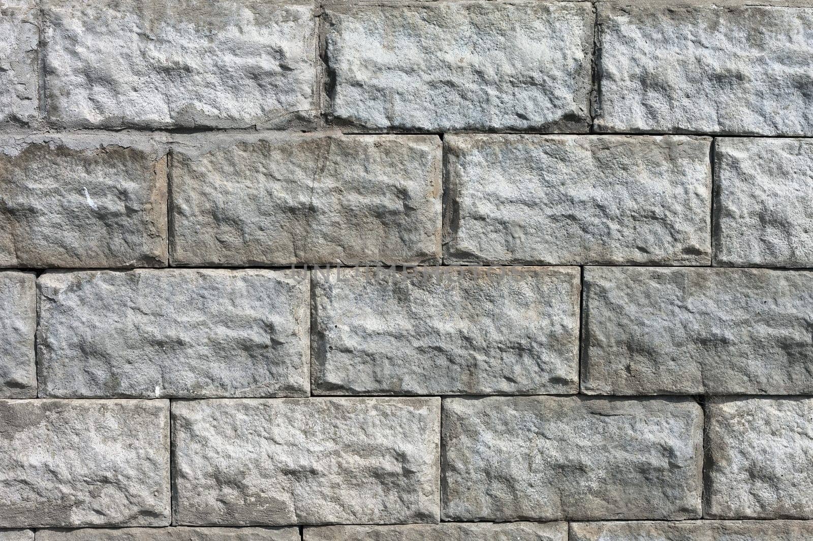 white roughly textured brick wall painted with white paint