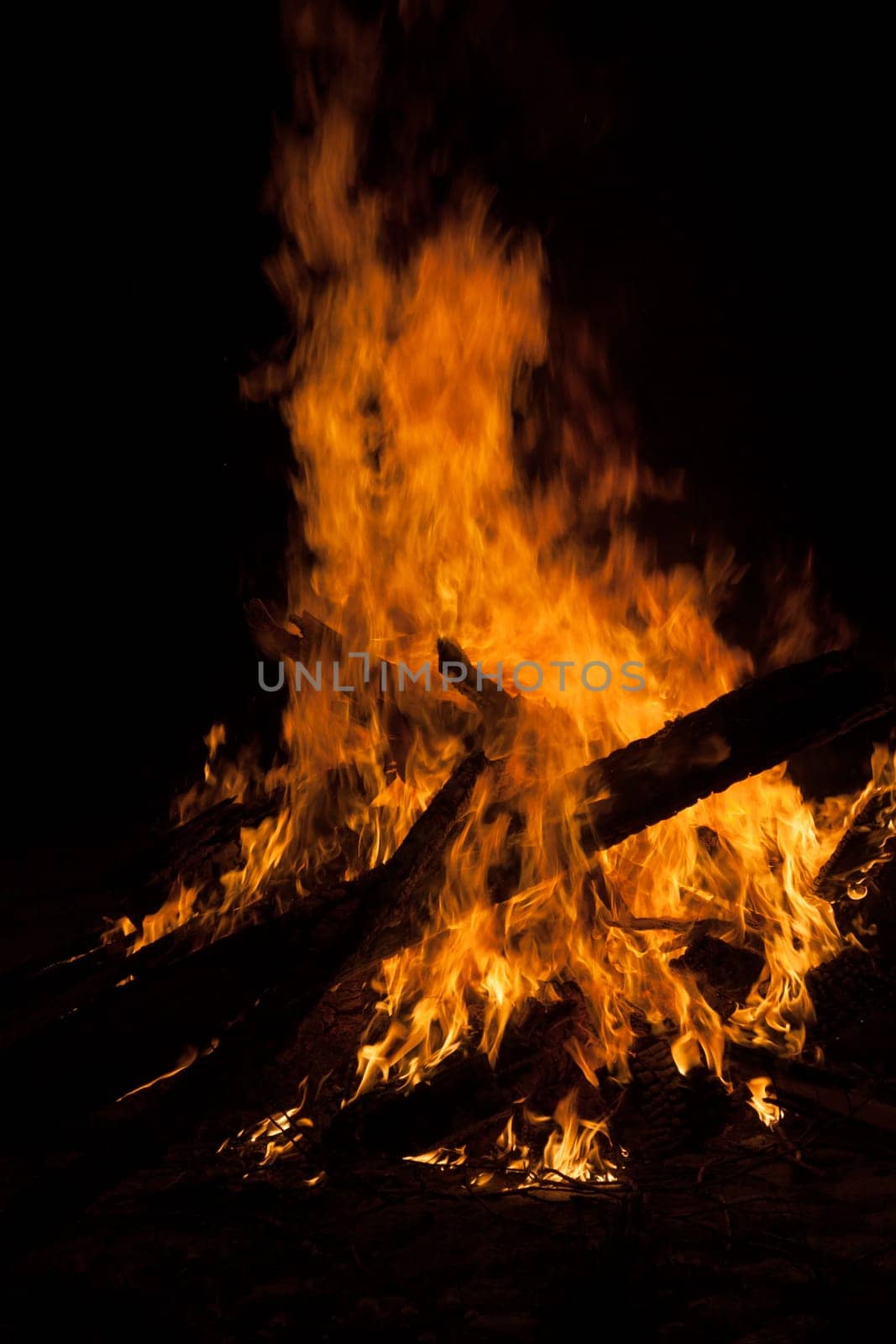 Large campfire in which boards burn