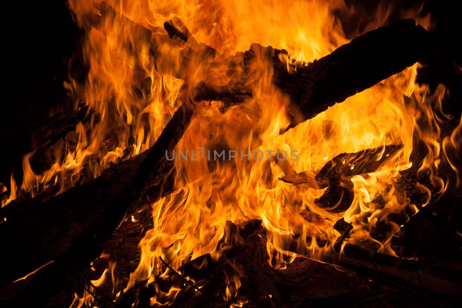 Large campfire in which boards burn