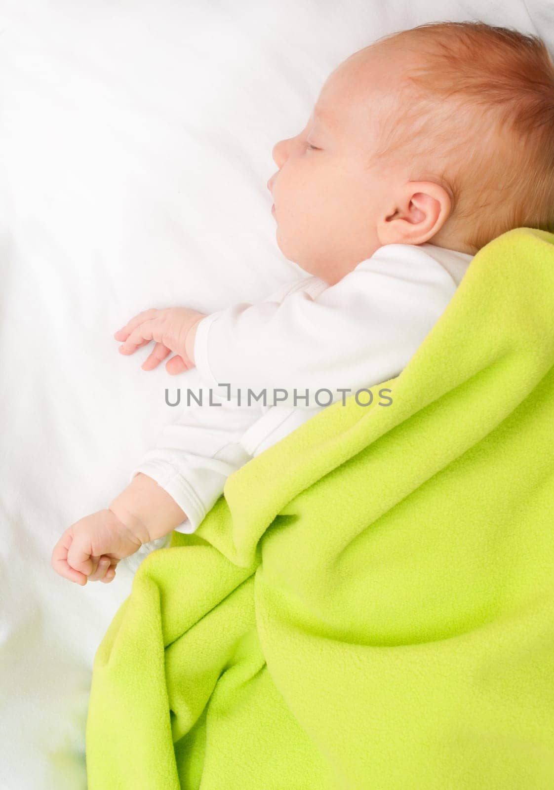 Sleeping Newborn Baby Under Green Blanket
