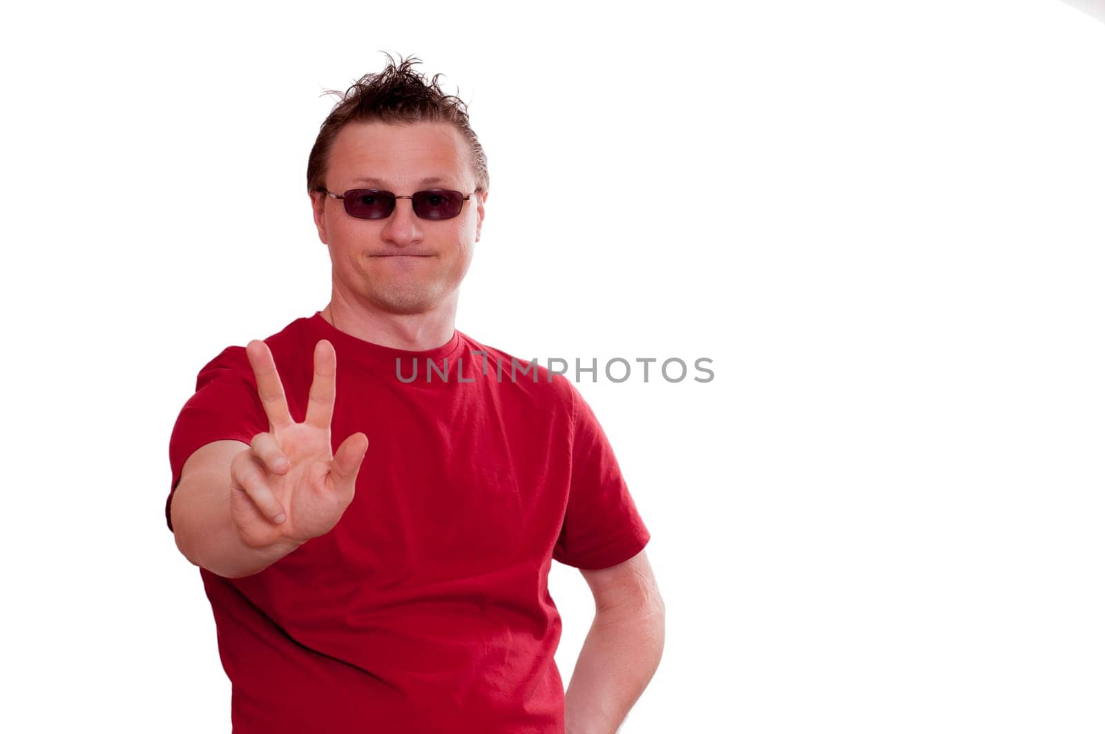 Man with grin holding hand forward with two fingers for peace hand signal