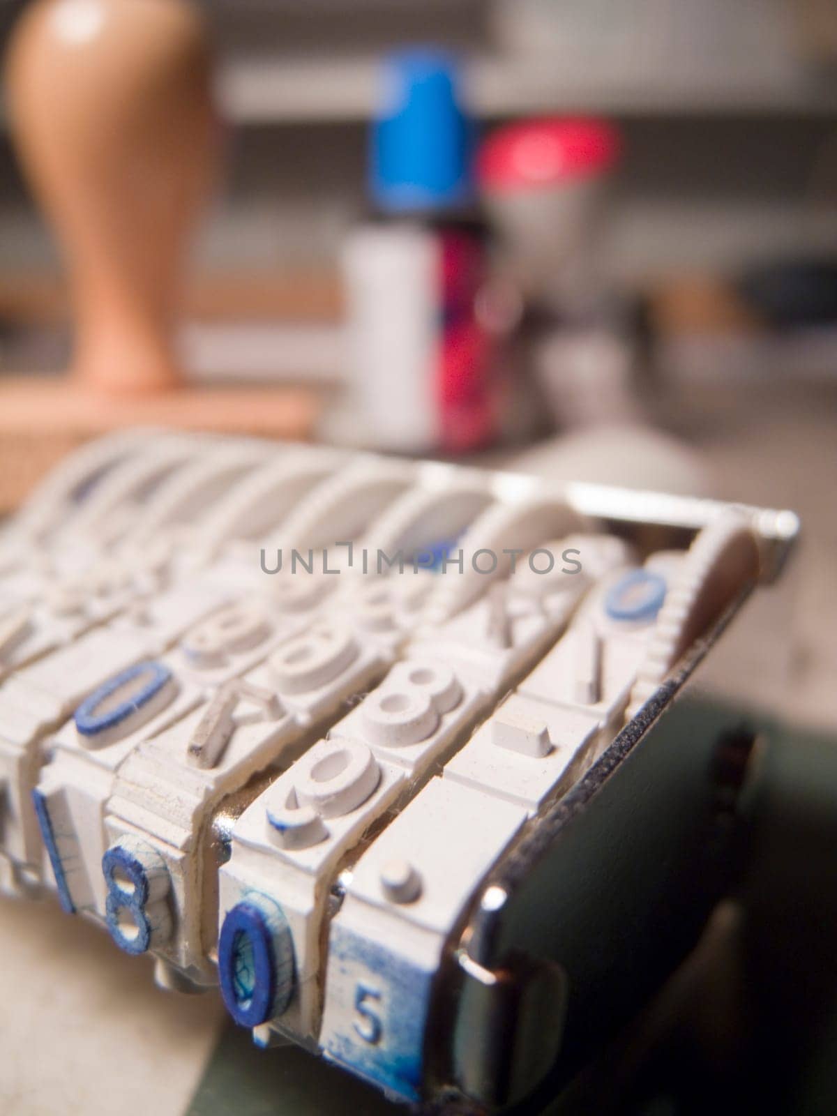 Close-up of a day stamp with office utensils standing behind it