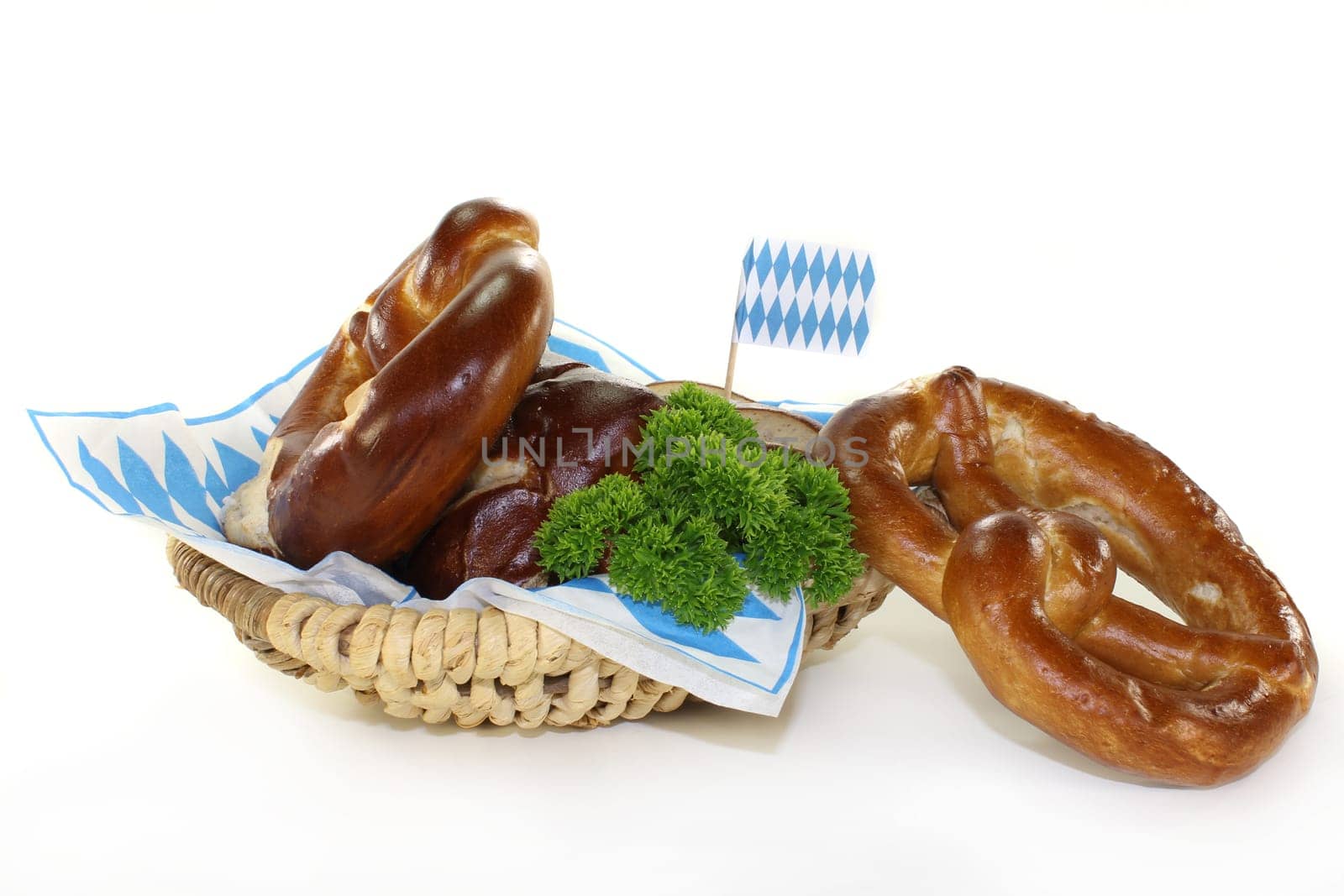 Pretzel pastries with parsley against a white background