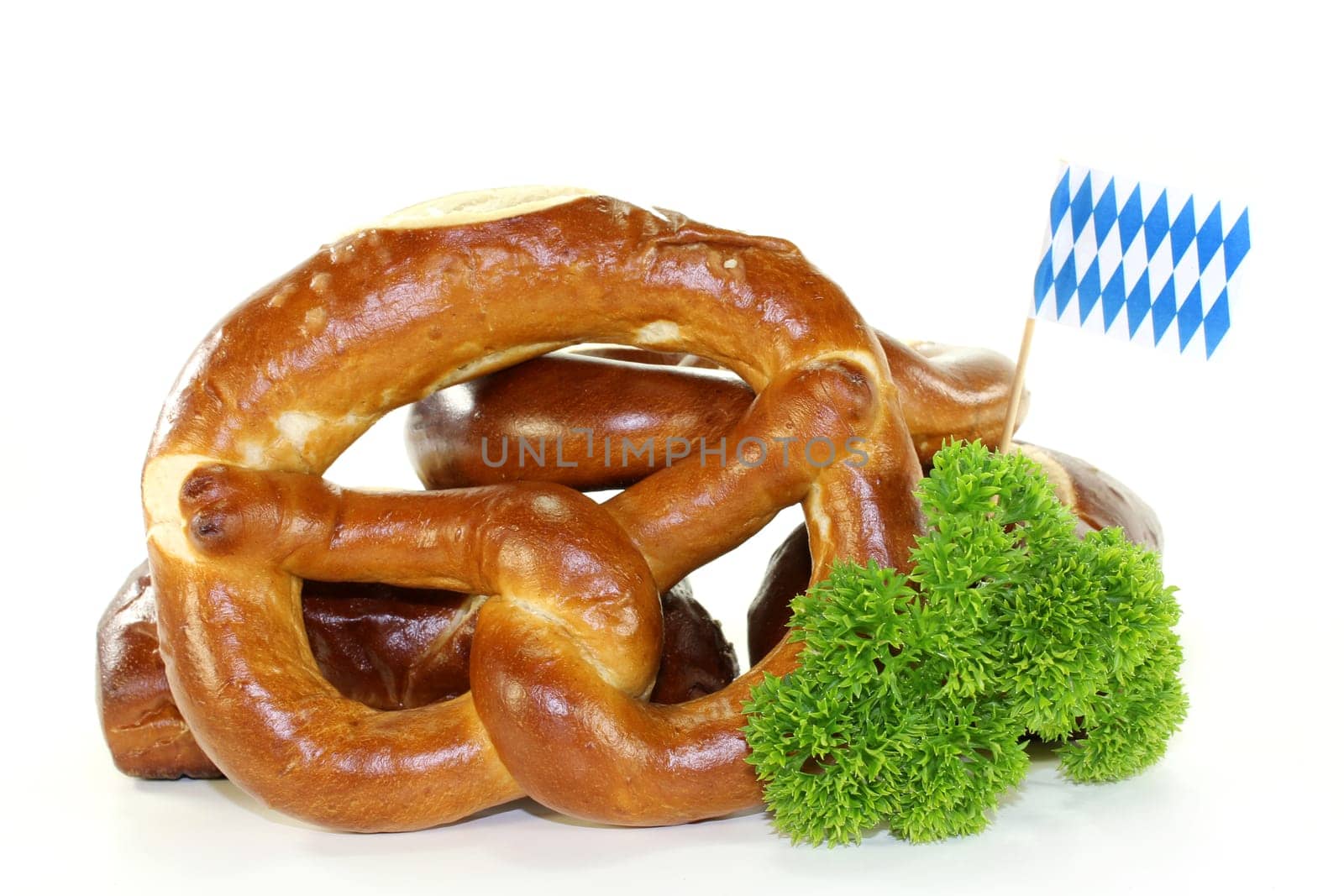 Pretzel pastries with parsley against a white background