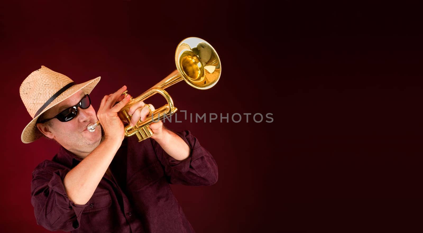 Trumpet Player trumpeting an announcement on a banner with copy space.