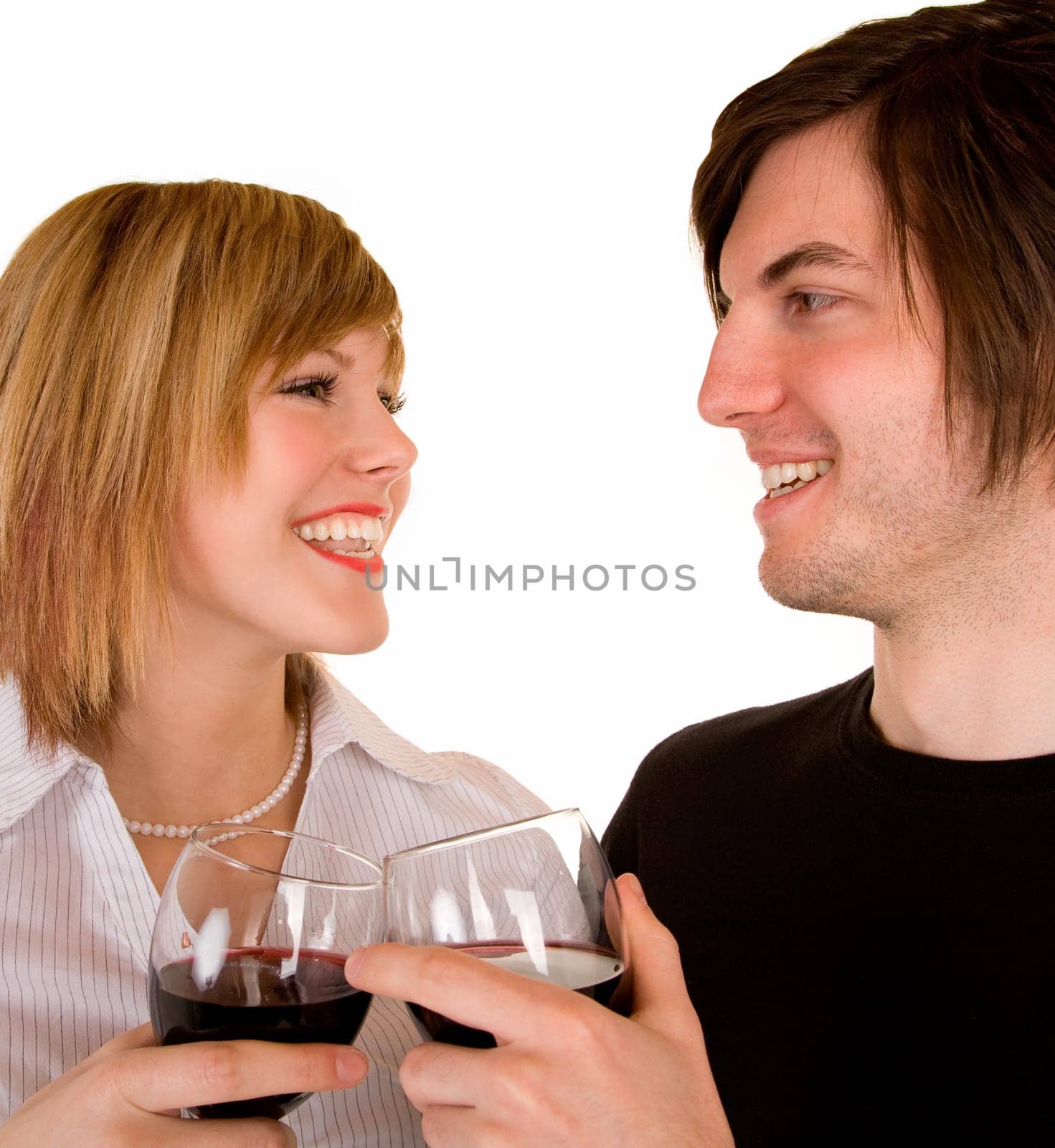 A young couple are having red wine