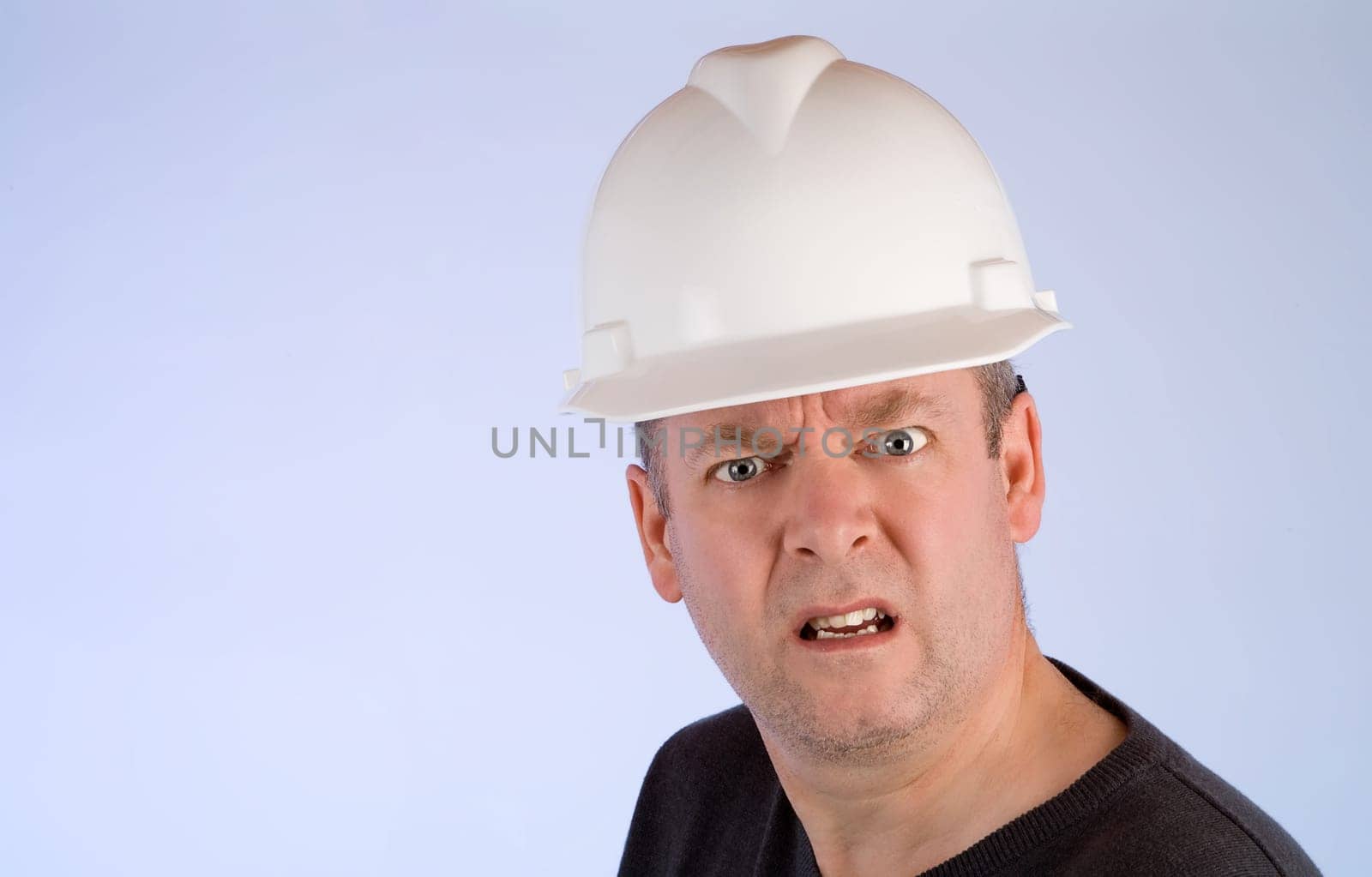 A construction worker is mad about something.
