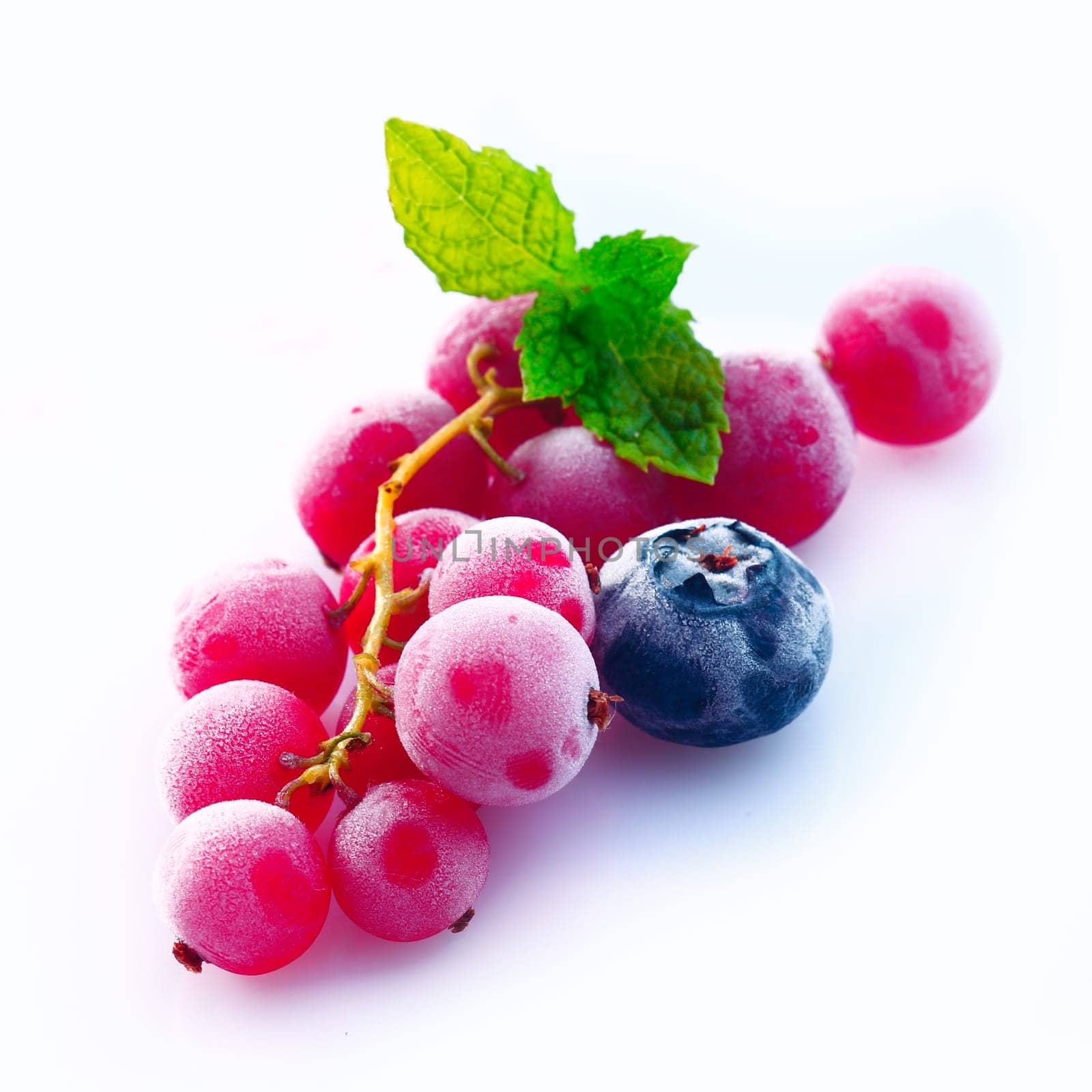 Assortment of chilled redcurrant, blueberry and raspberry berries with skins frosted with moisture