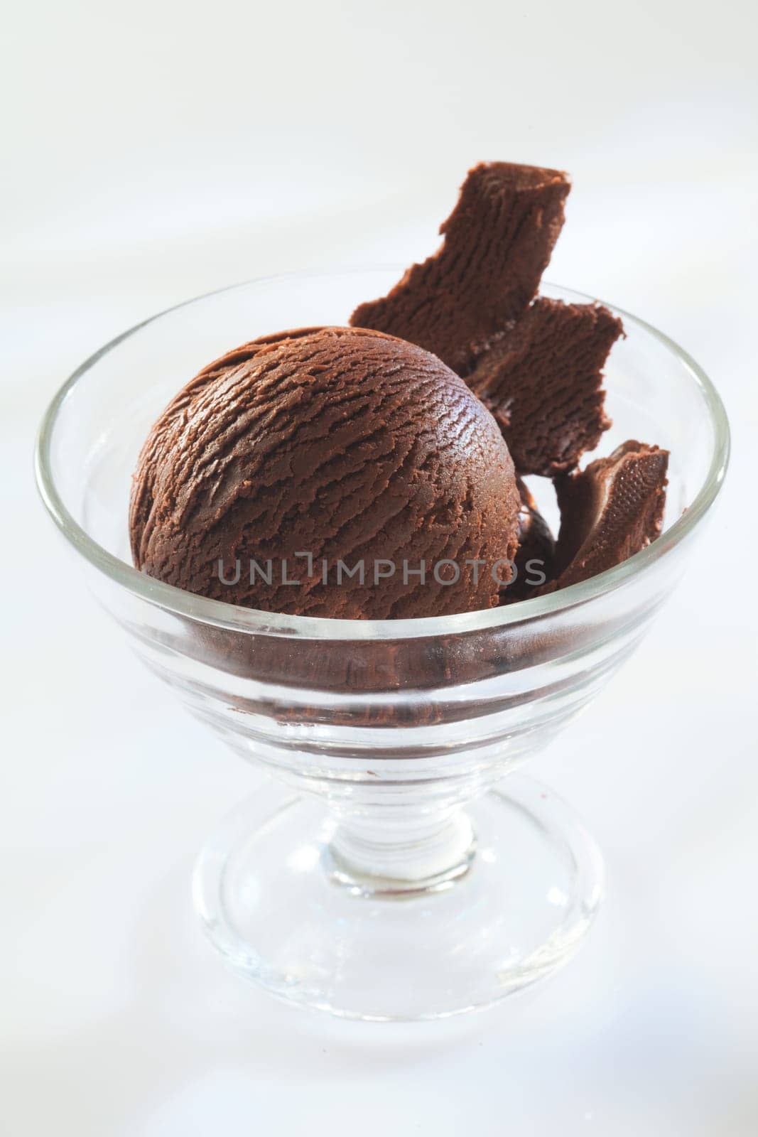 Rich gourmet chocolate icecream with dark chocolate shavings in a conical cocktail glass