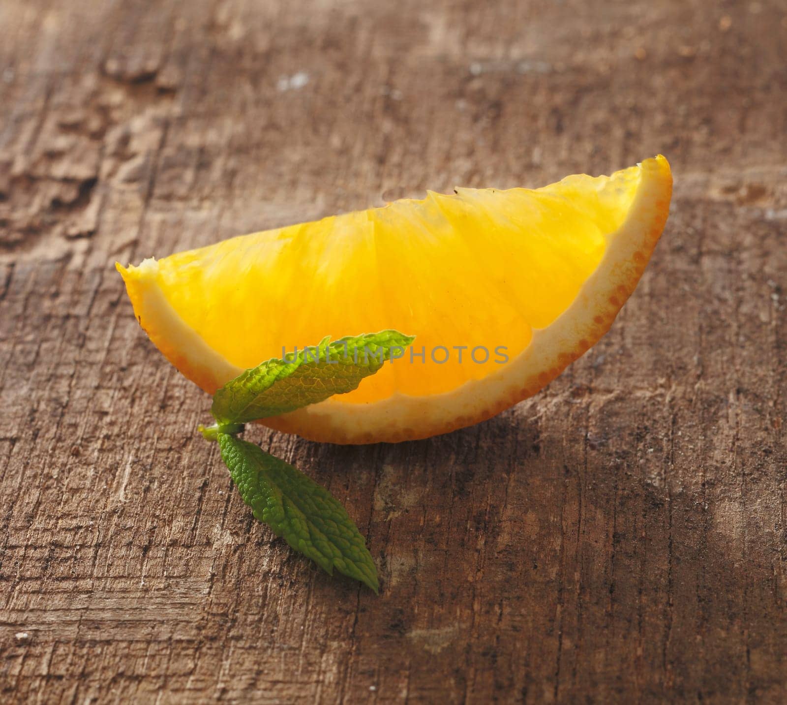 Slice of orange on a vintage wooden background