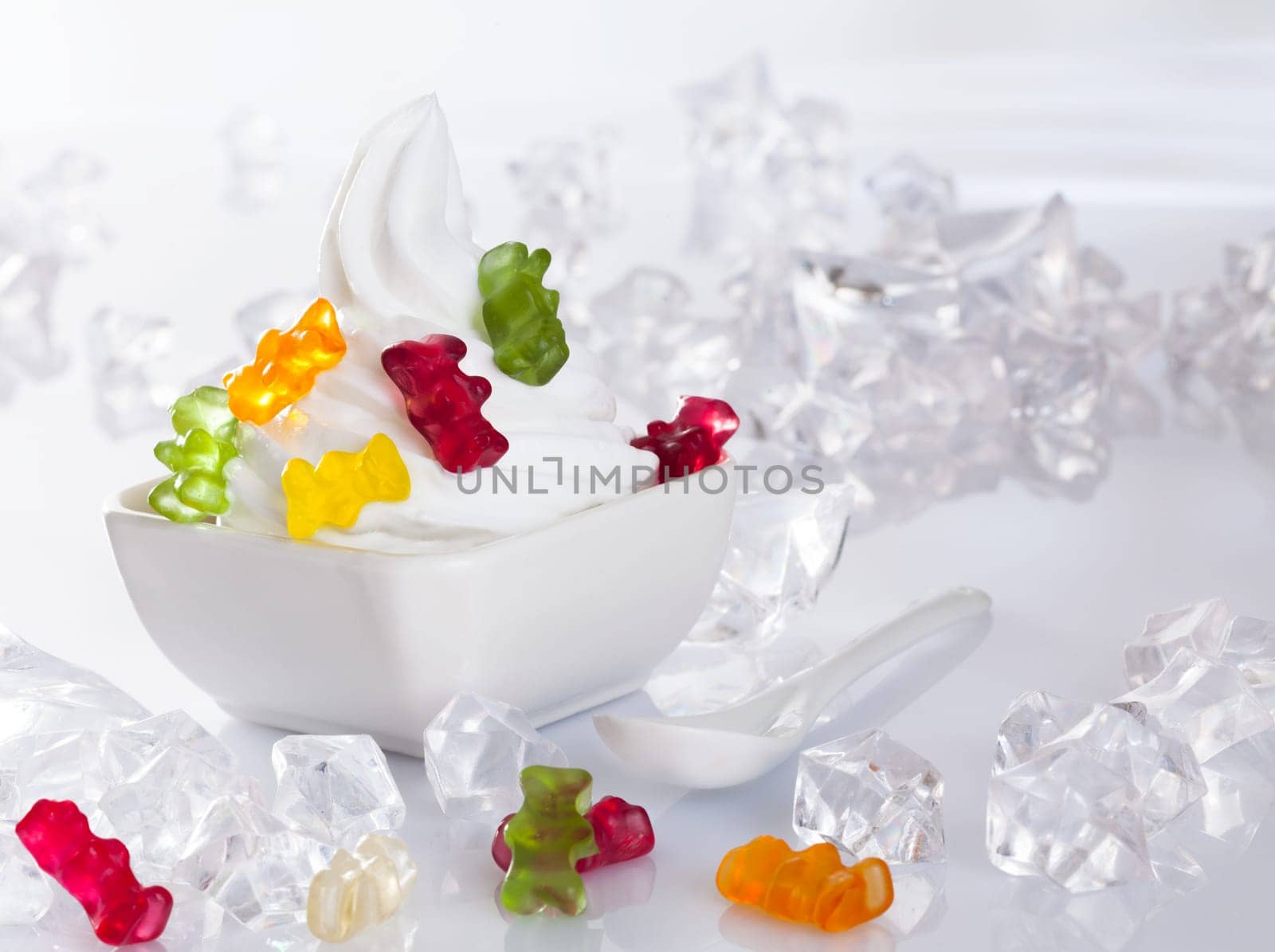 Cold Frozen yogurt Dessert served with ice cubes and brightly gummi bears