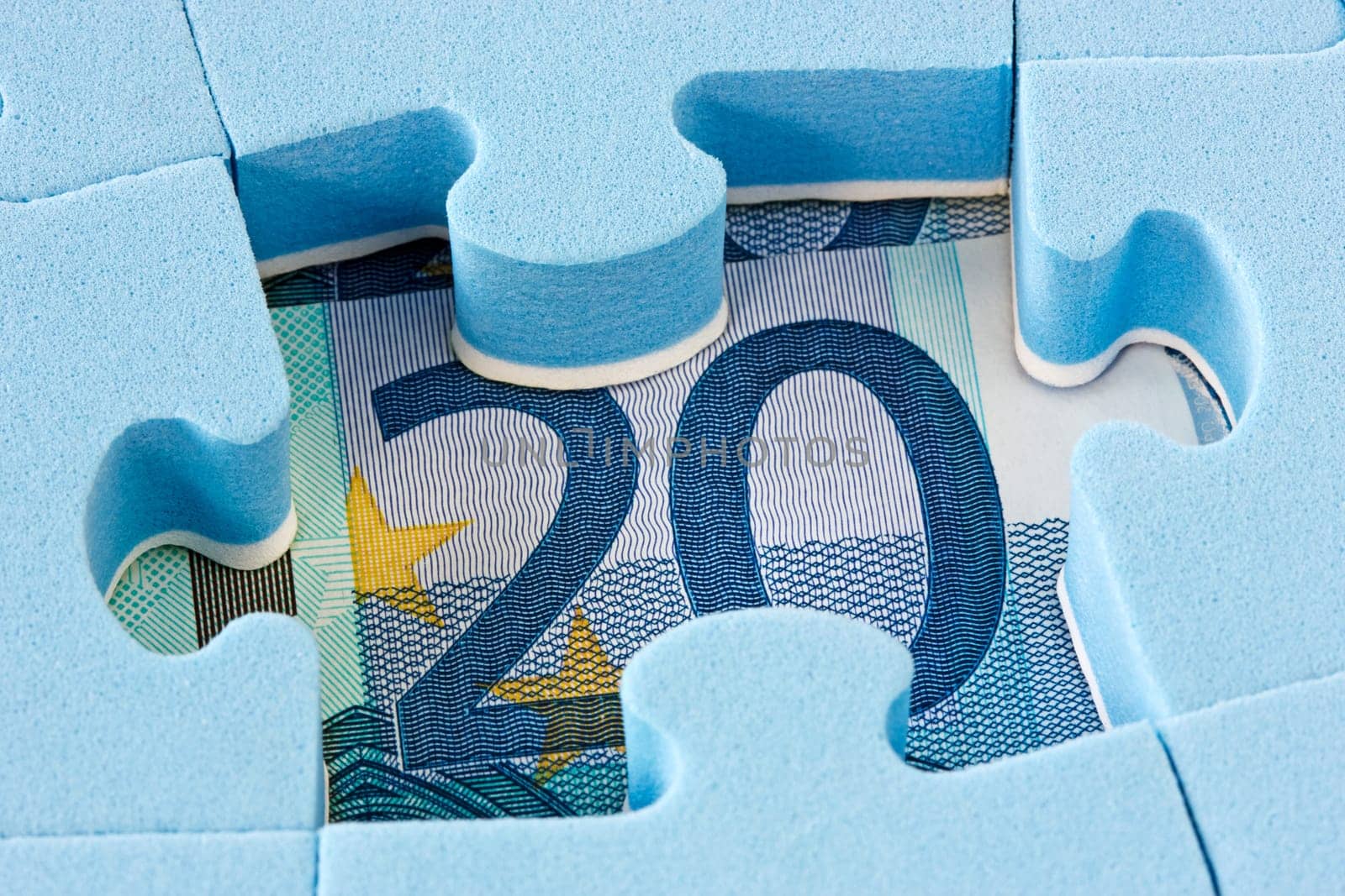 Hidden assets concept. Blue puzzle on Euro currency