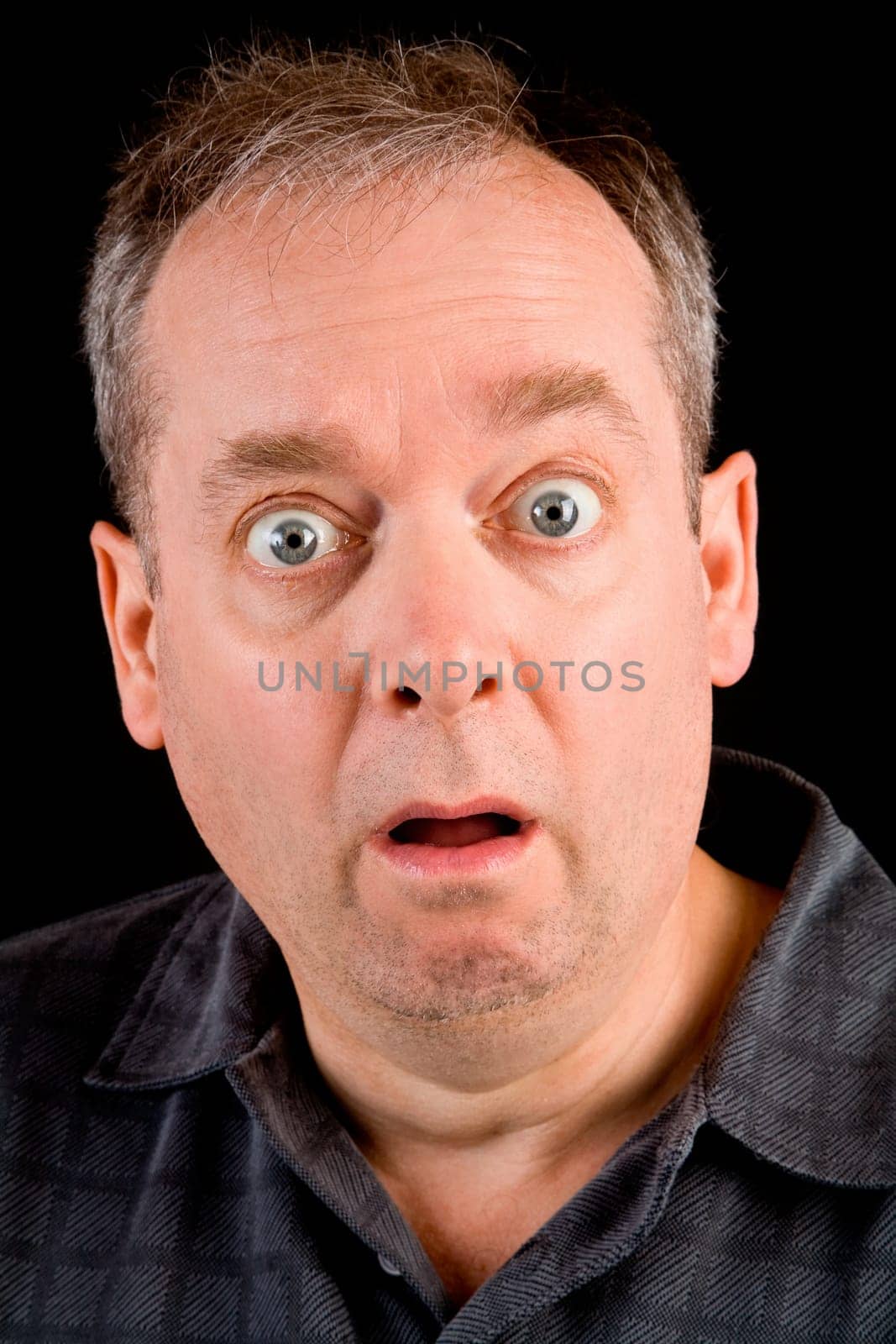 The face of a man being afraid or shocked of something.