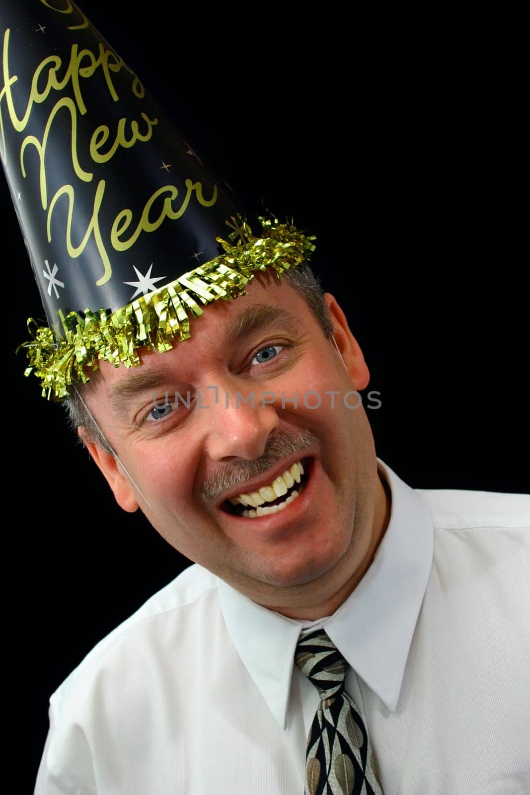Man wearing "New Year party"" hat and cheering the people in front of him."
