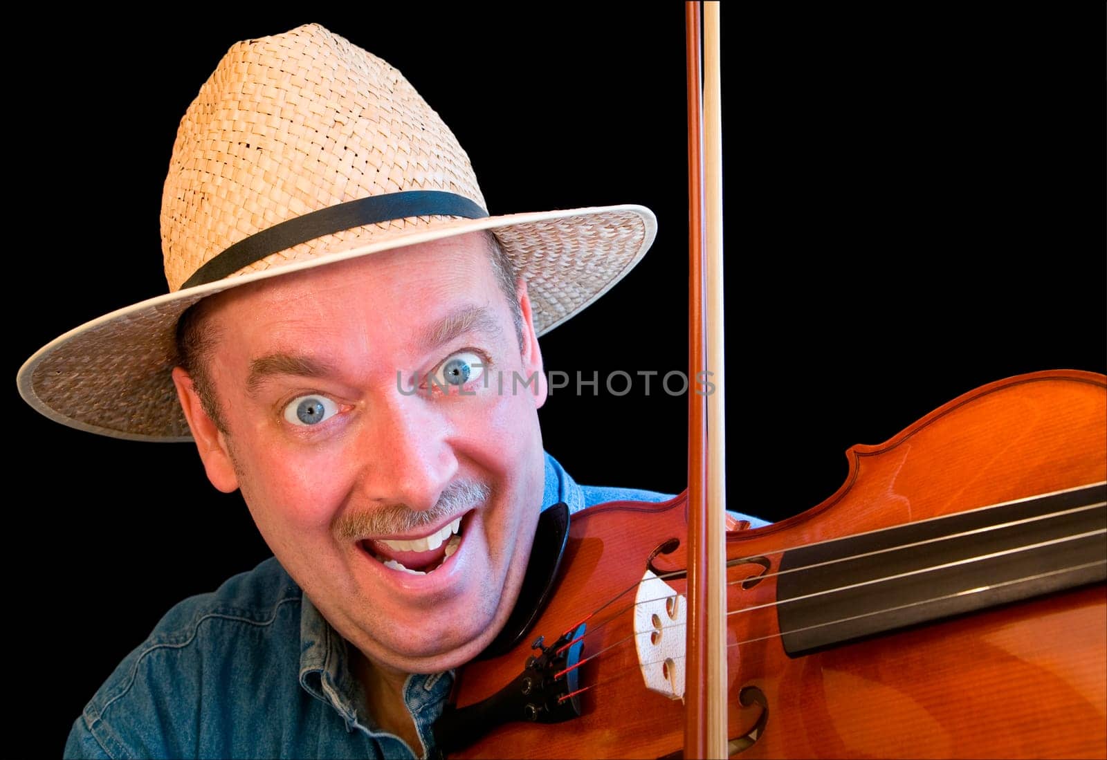 A man is playing country music on the fiddle.