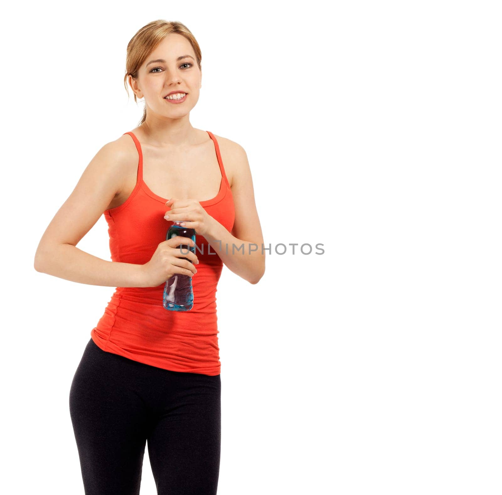 Young pretty sportswoman opening water bottle against white background