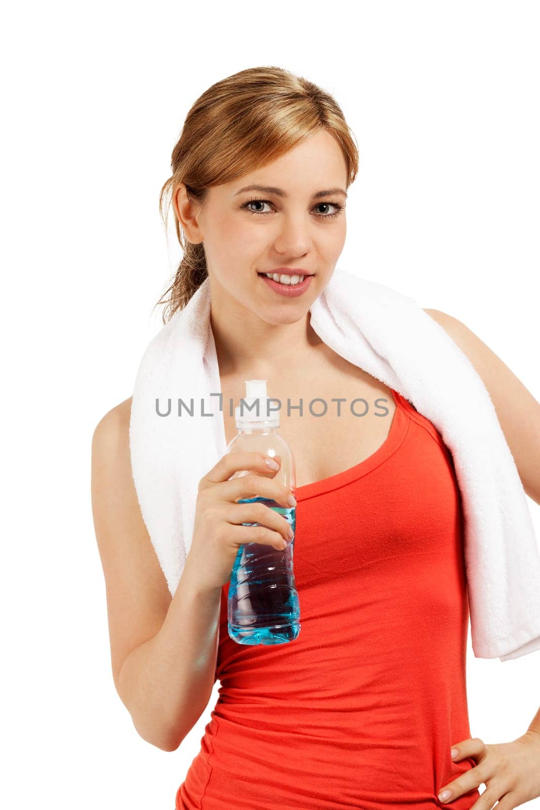 Smiling sportswoman with a bottle of water and a towel against a white background