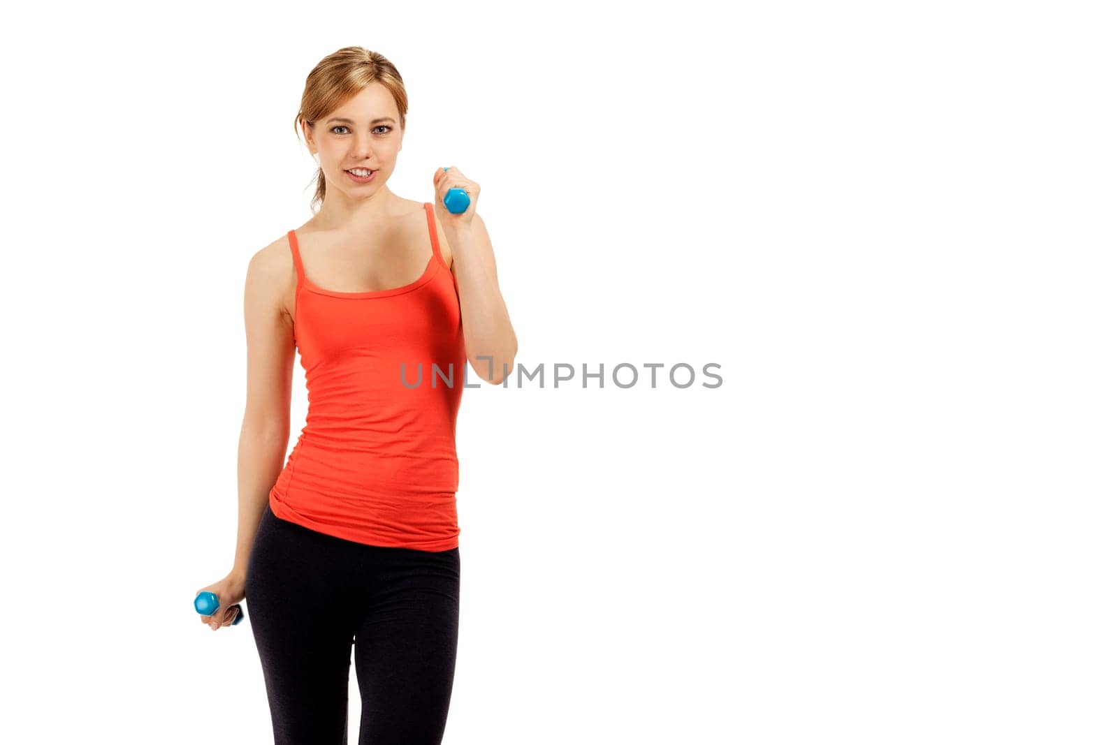 Pretty young sportswoman exercising with dumbbells against white background