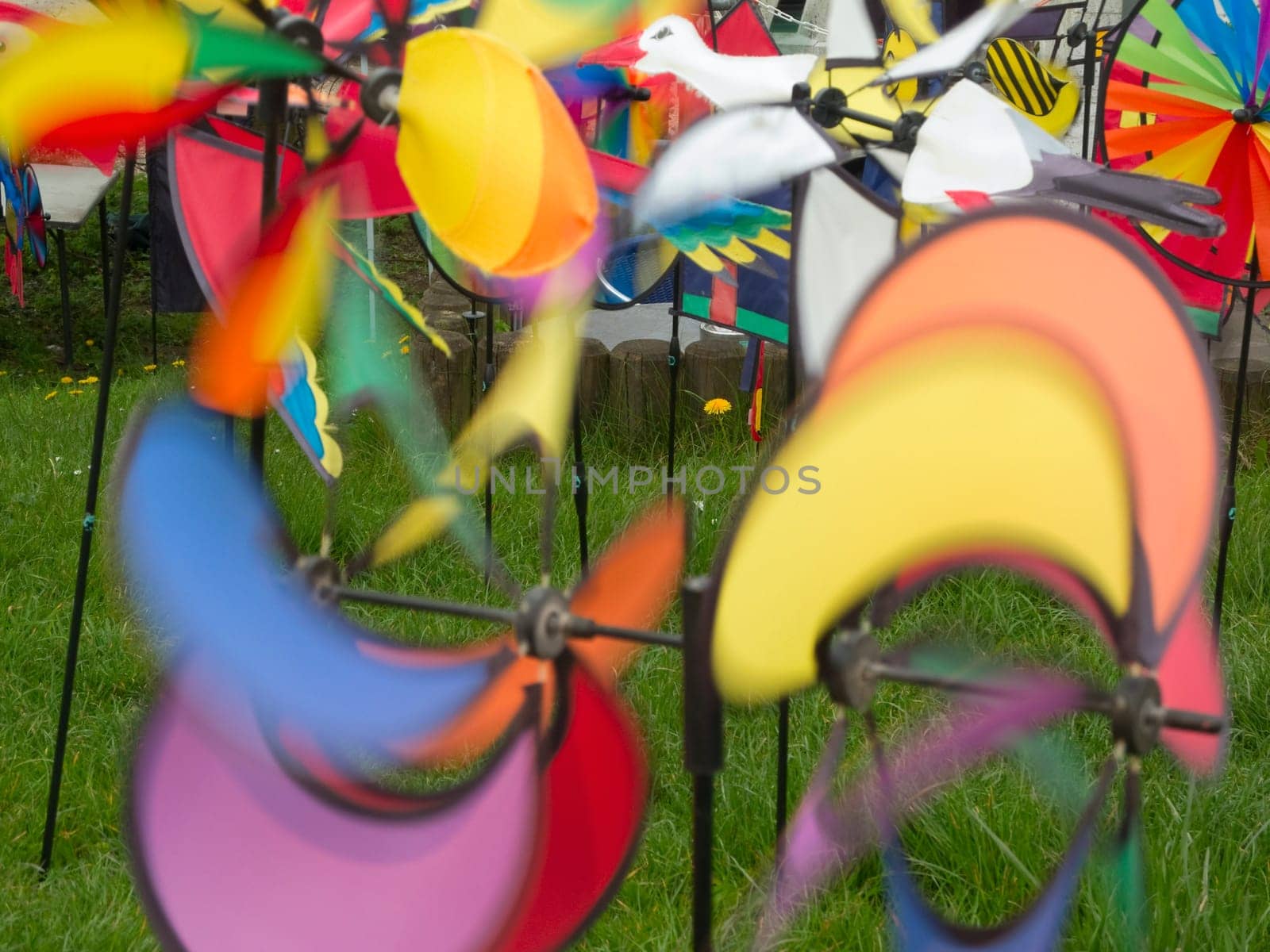 Colorful spinning pinwheels in a meadow captured with a long exposure.