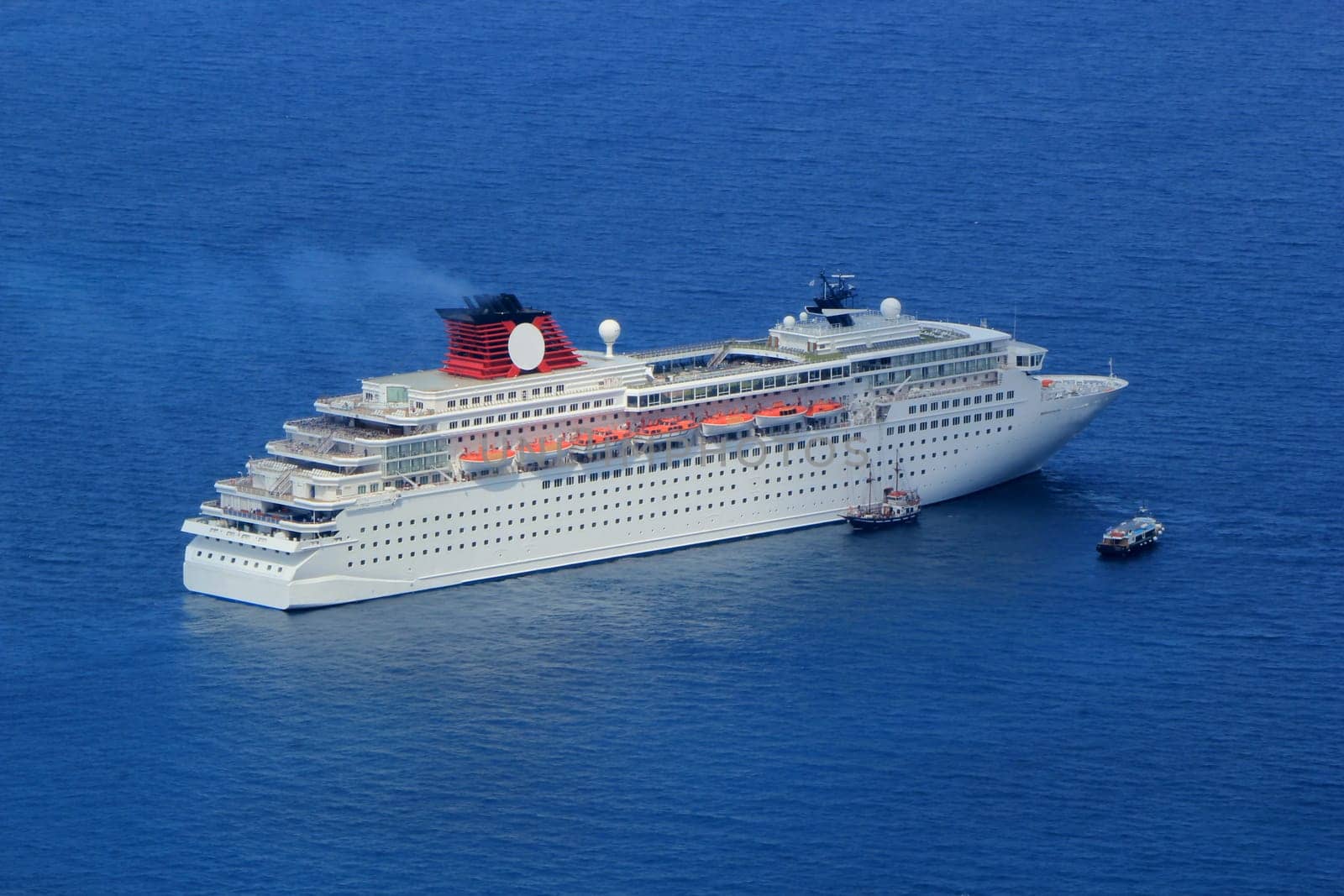 Big cruise ship and two small boats on the Aegean sea, Greece