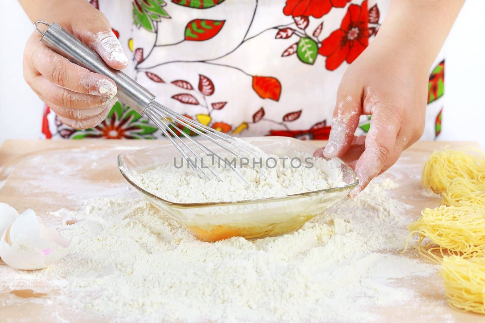 Details of woman&#039 s hands mixing dough