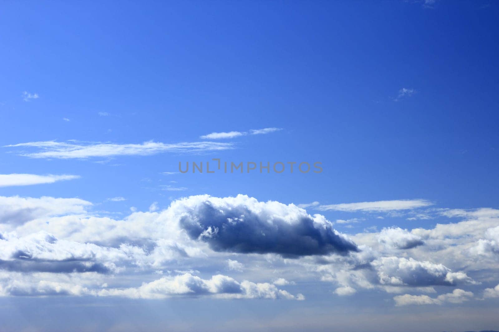 Decorative cloud formations against blue sky
