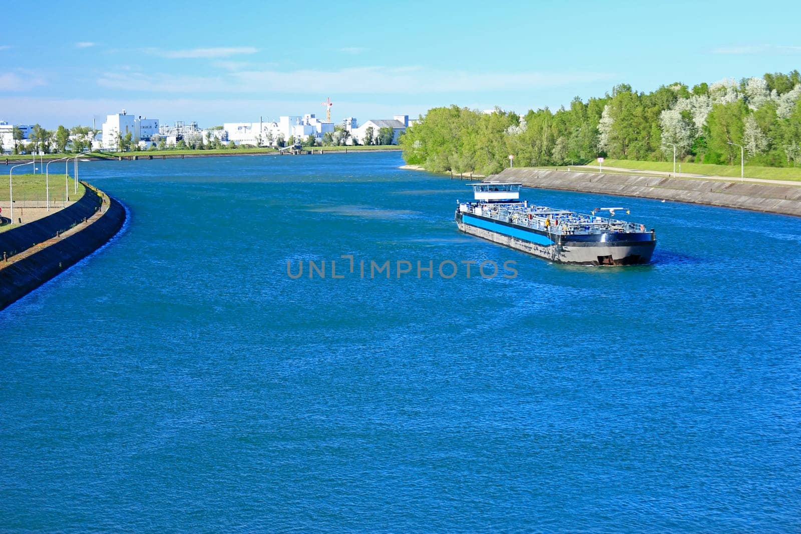 Cargo ship at the Rhine lock and Grens crossing near Marckolsheim (France) and Sasbach am Kaiserstuhl (Germany)