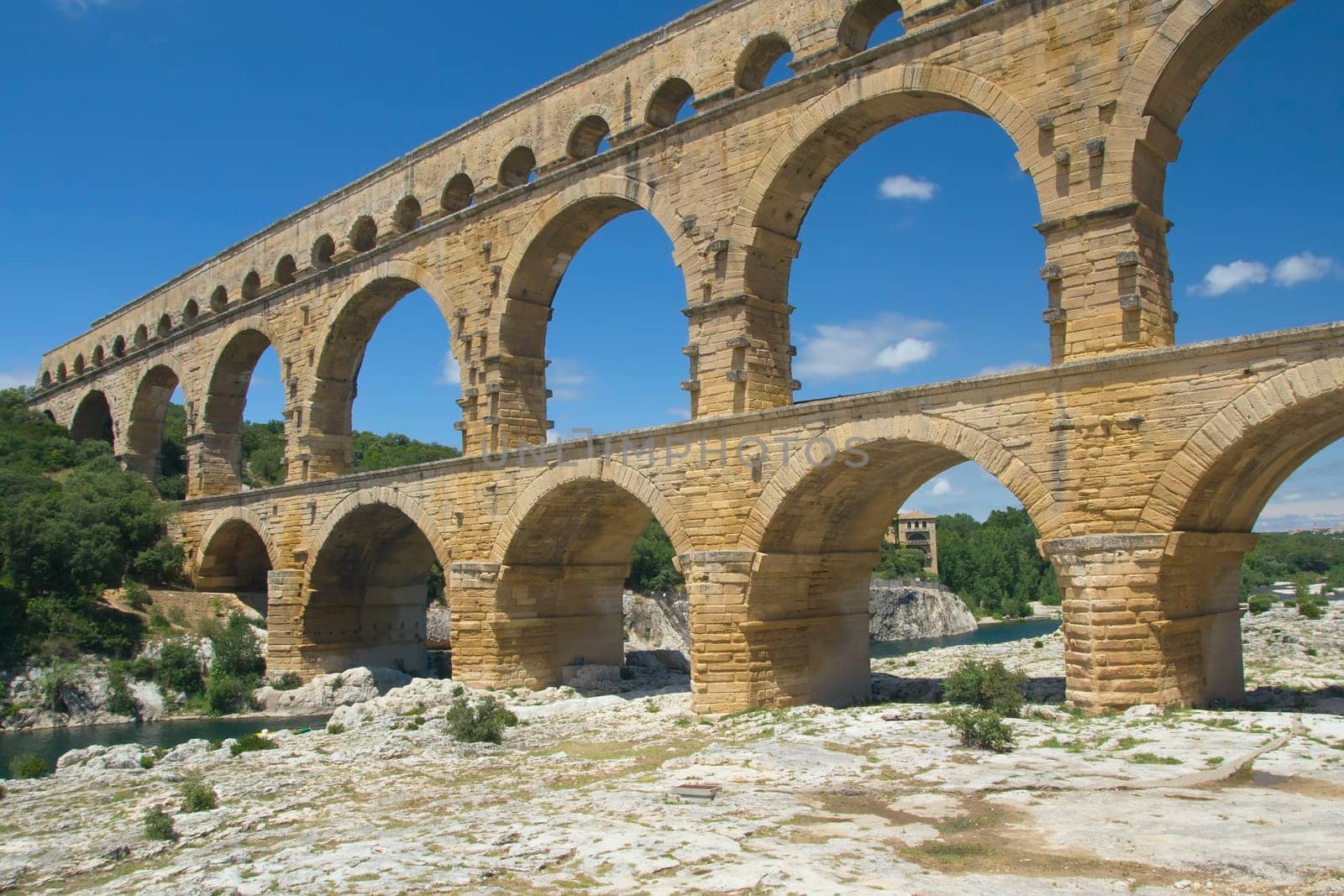 The Pont du Gard is an ancient Roman aqueduct bridge that crosses the Gardon River in southern France