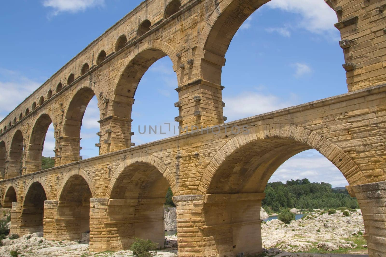 The Pont du Gard is an ancient Roman aqueduct bridge that crosses the Gardon River in southern France