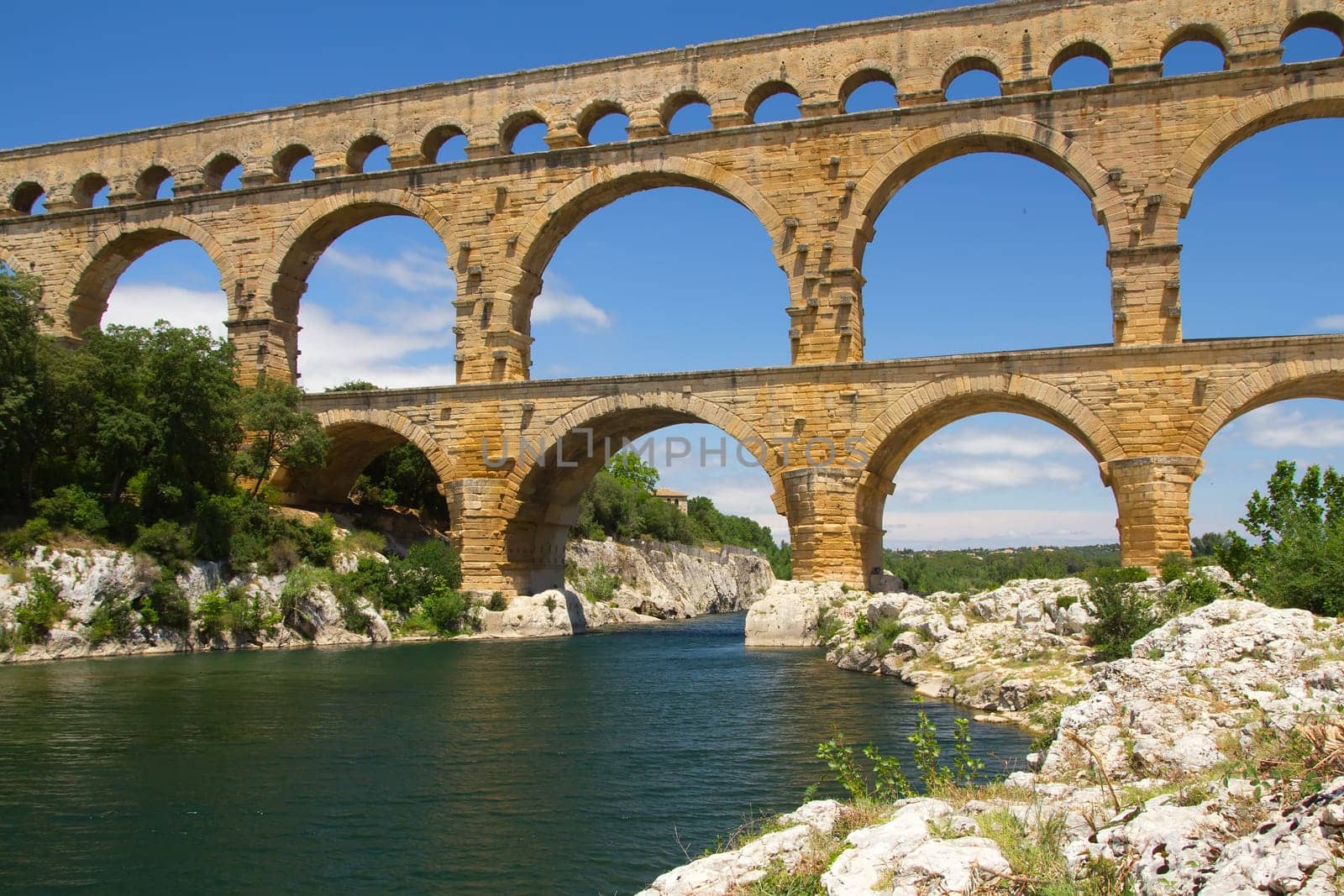 The Pont du Gard is an ancient Roman aqueduct bridge that crosses the Gardon River in southern France