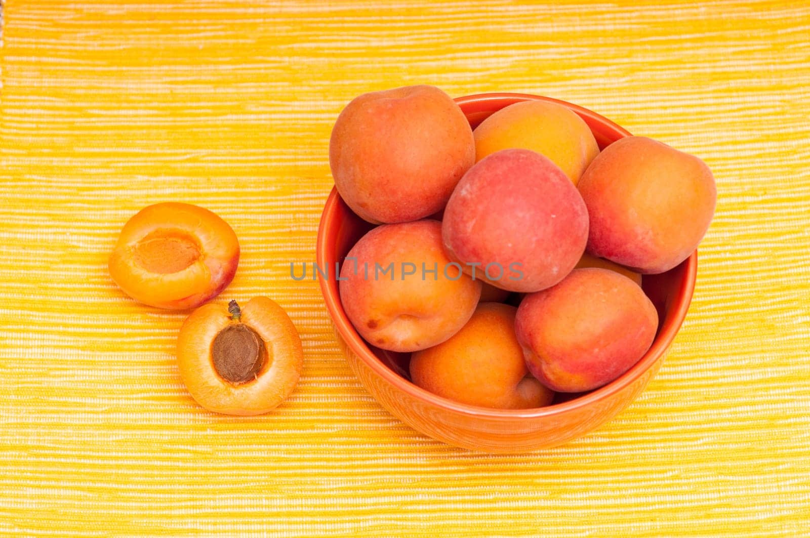 Apricot and apricot kernel on yellow background