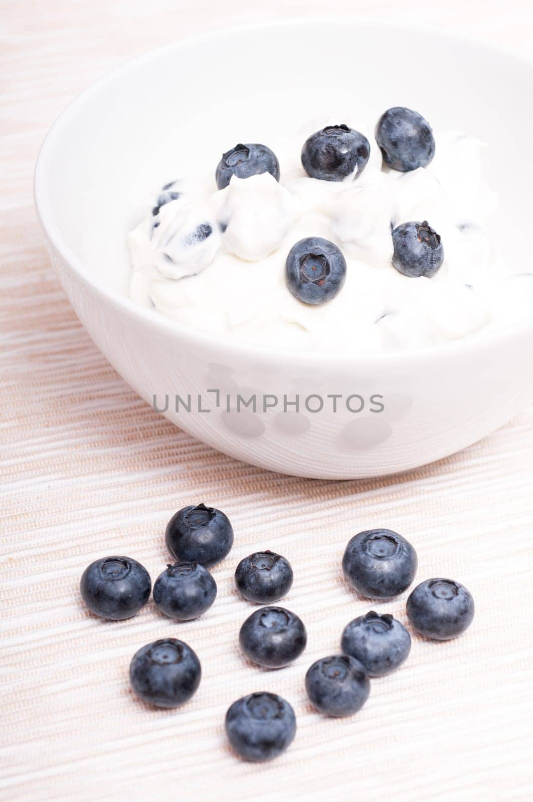 Blue blueberries with quark in portrait format