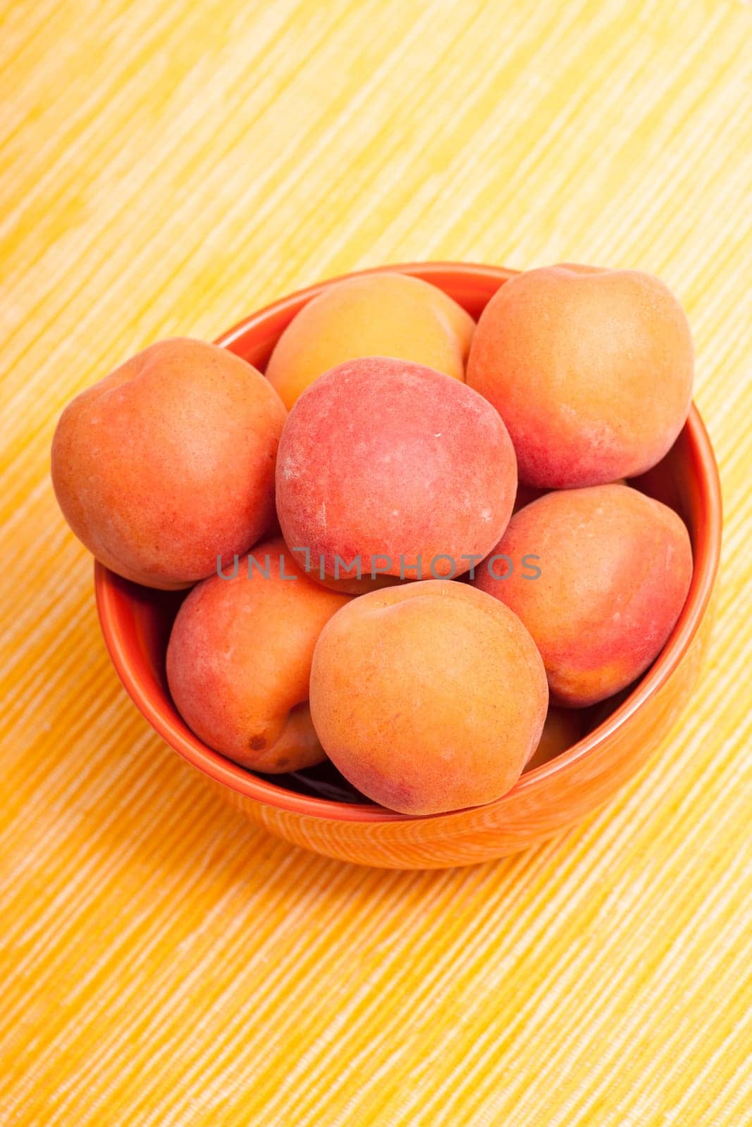 Ripe apricots in a bowl in portrait format