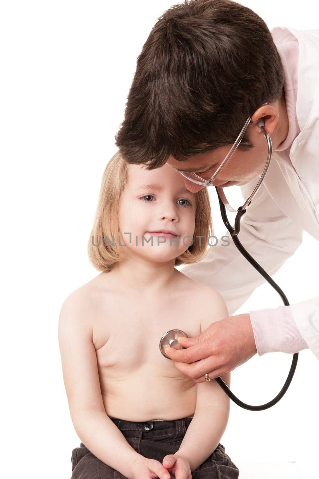 Toddler at pediatrician in front of white background