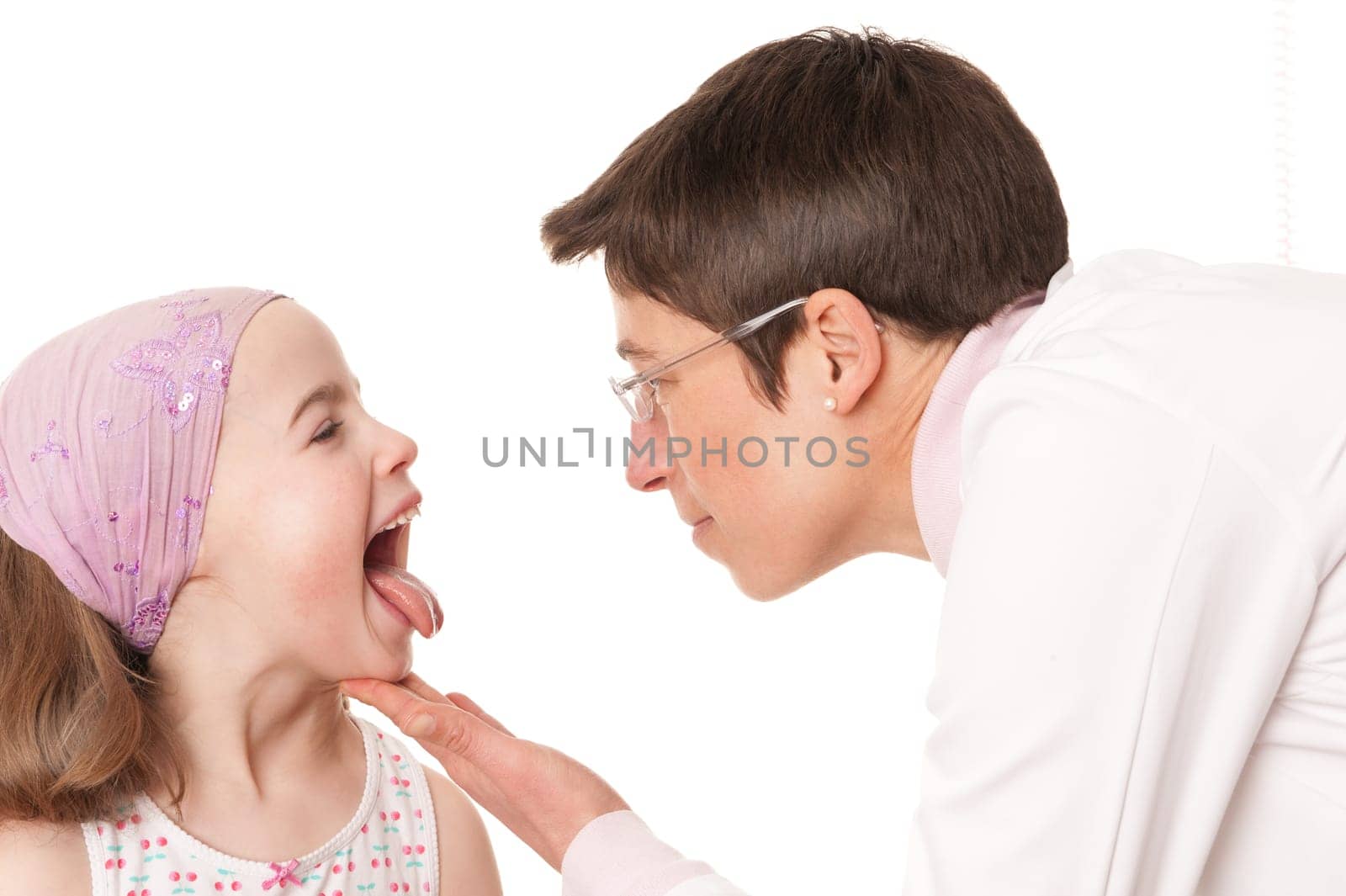 Toddler at pediatrician in front of white background