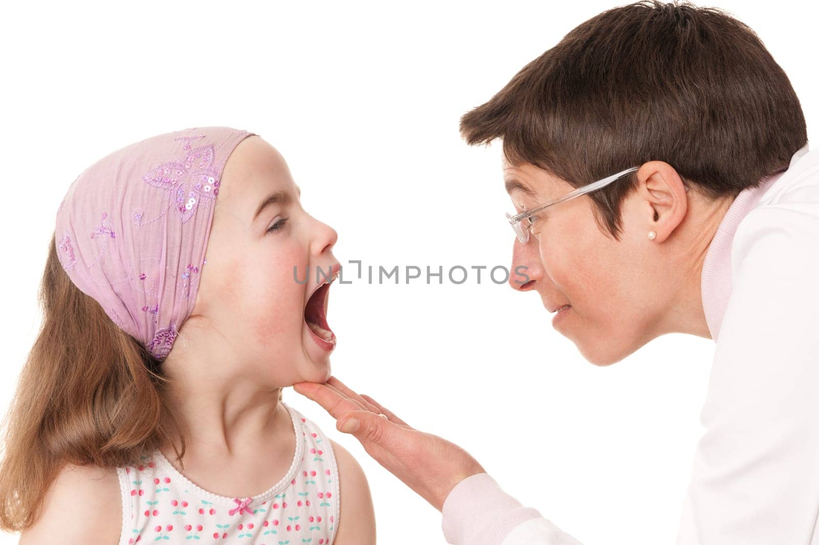 Toddler at pediatrician in front of white background