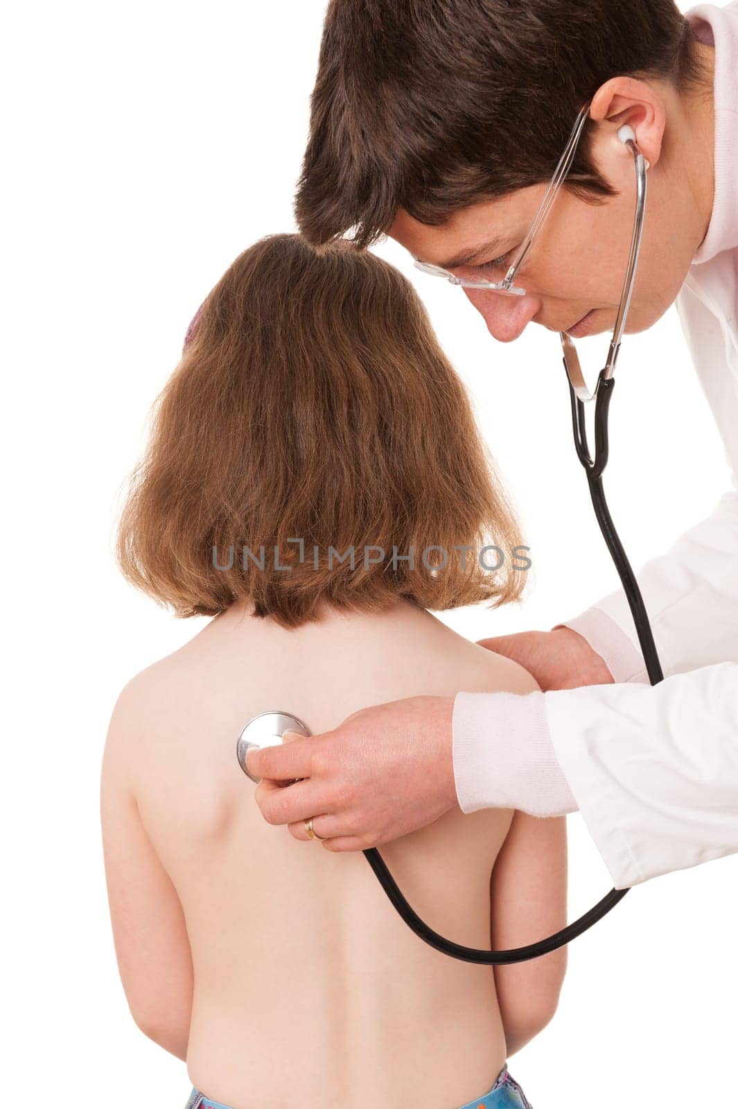 Toddler at pediatrician in front of white background