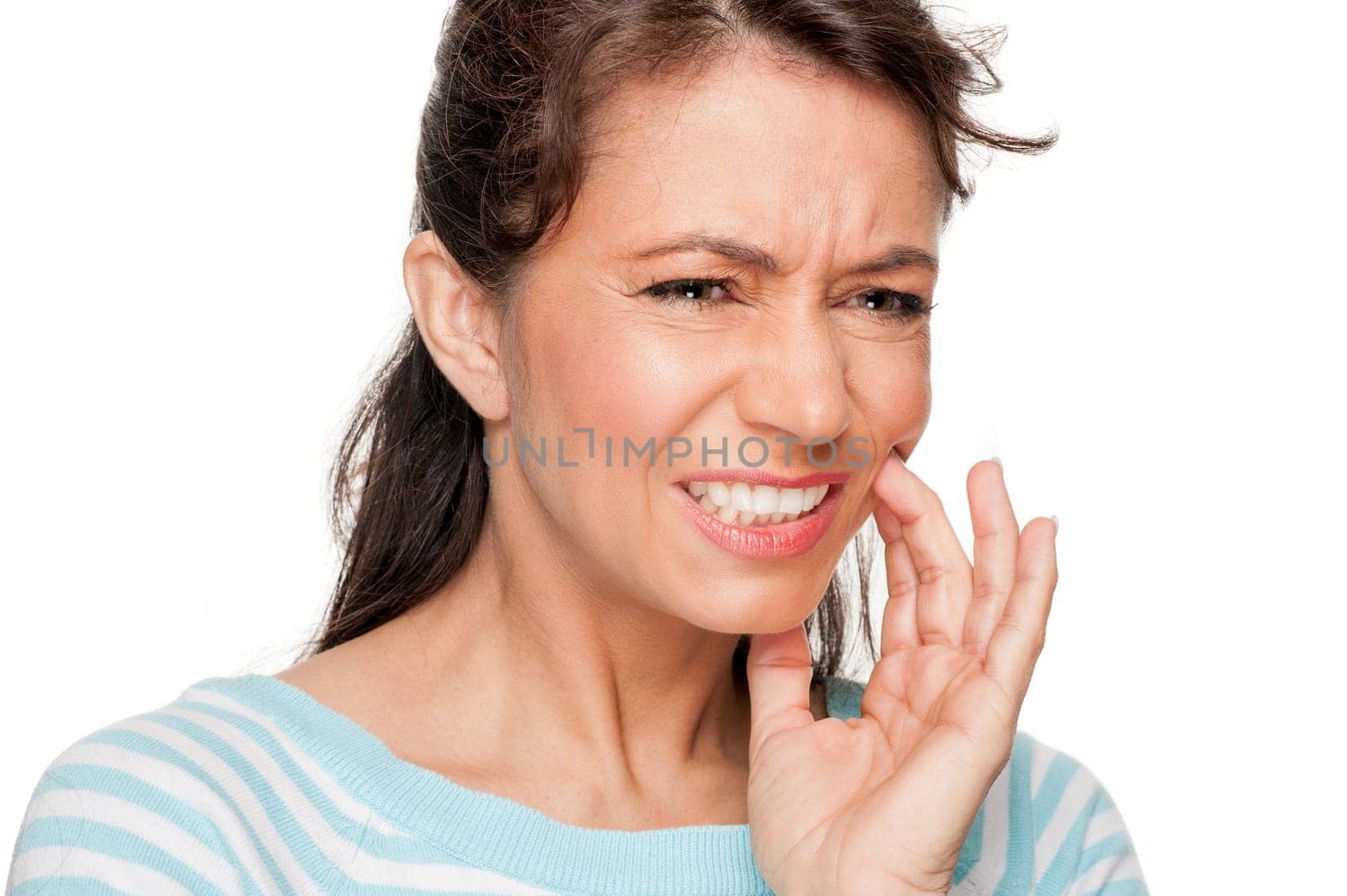Young woman in front of white background with toothache