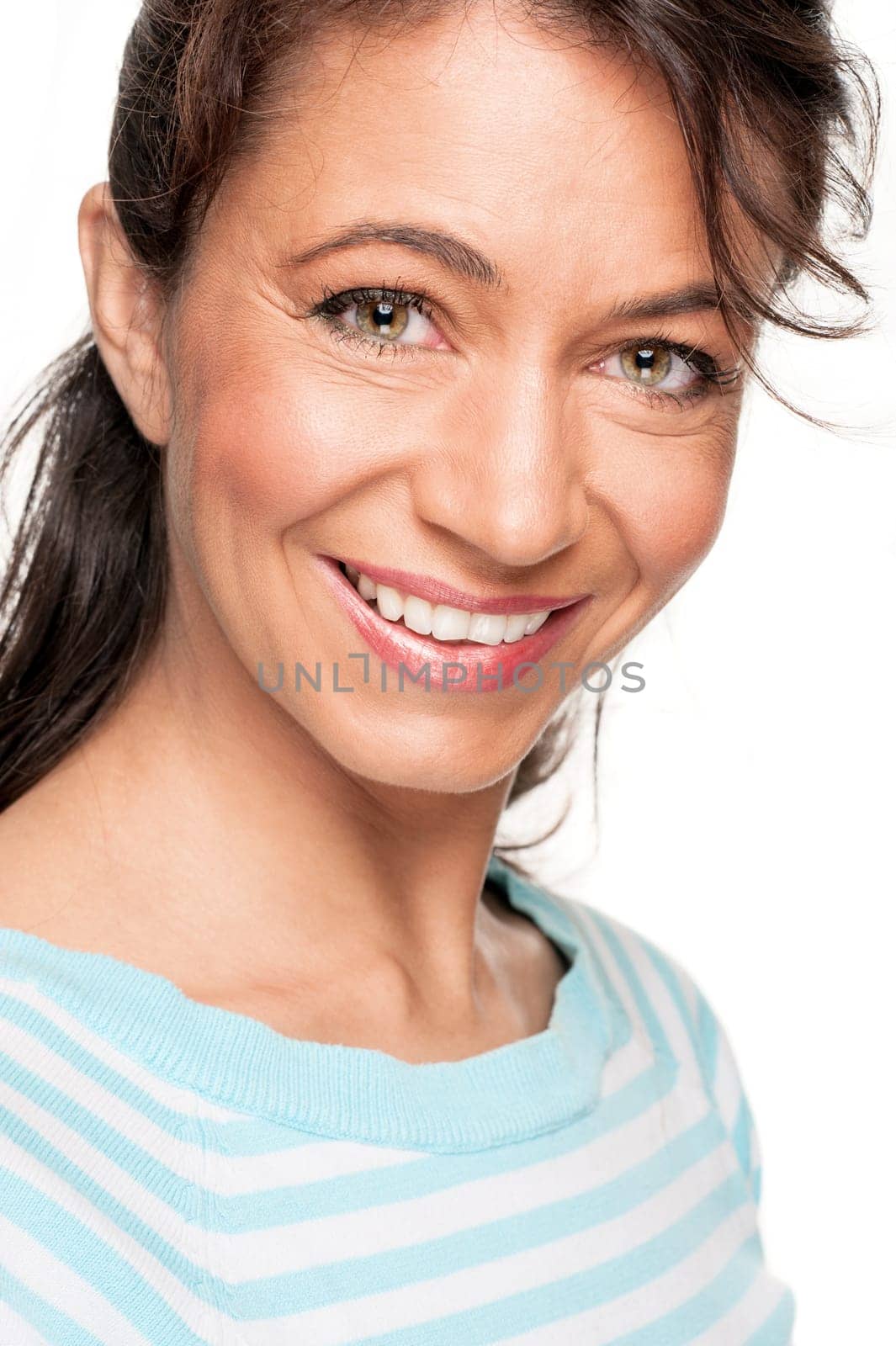 Young and smiling woman in front of white background