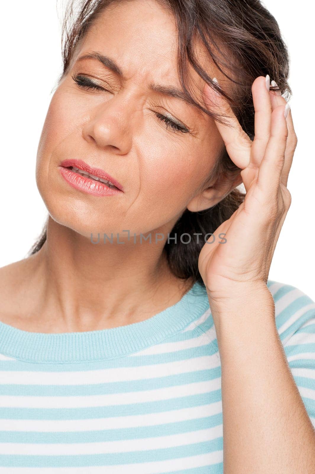 Young woman in front of white background with headache