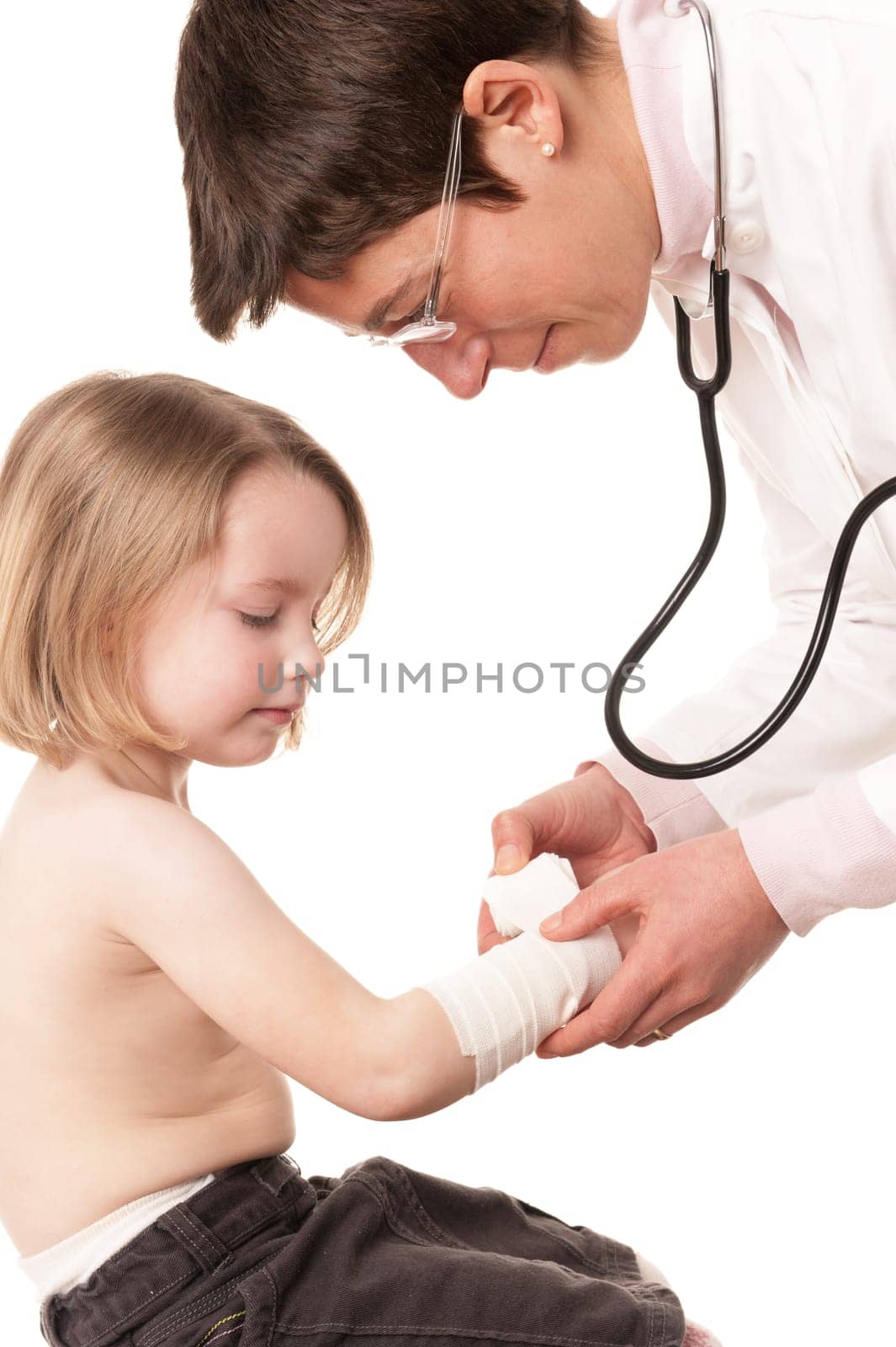 Toddler at pediatrician in front of white background