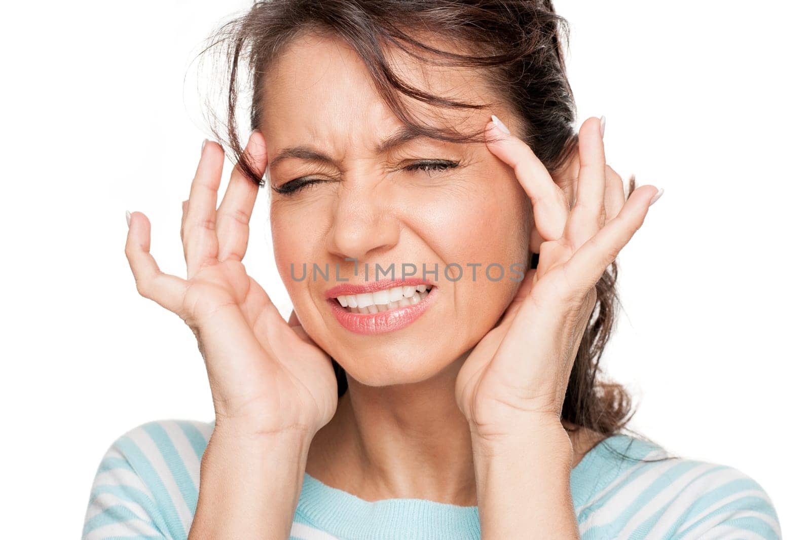 Young woman in front of white background with headache