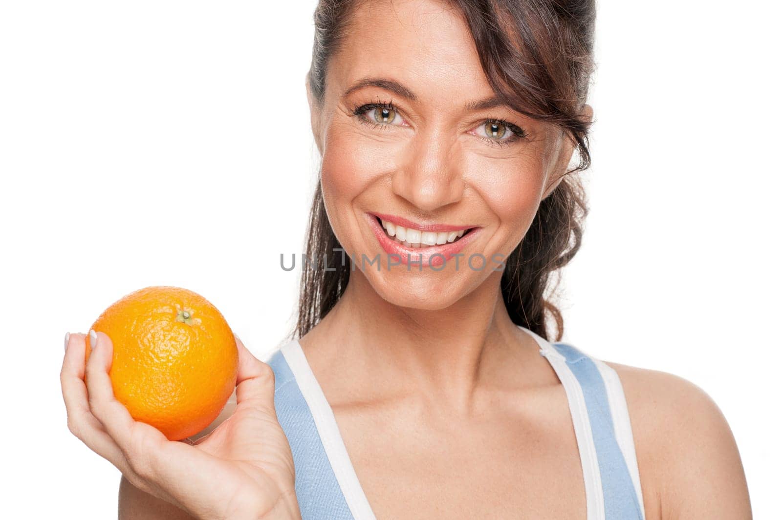 Smiling woman in front of white background with an orange