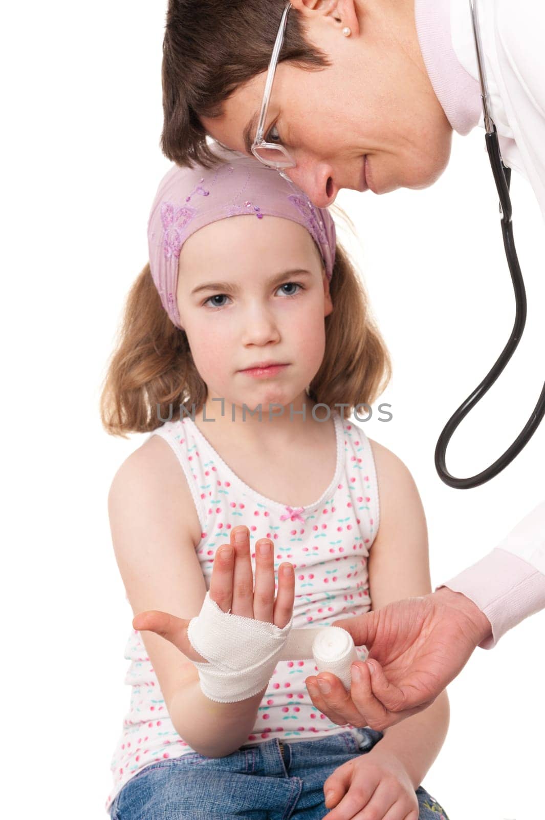 Toddler at pediatrician in front of white background