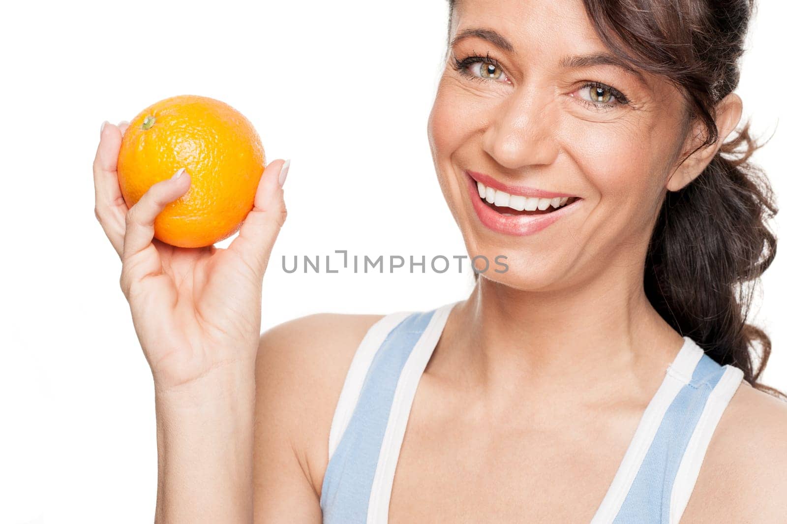 Smiling woman in front of white background with an orange