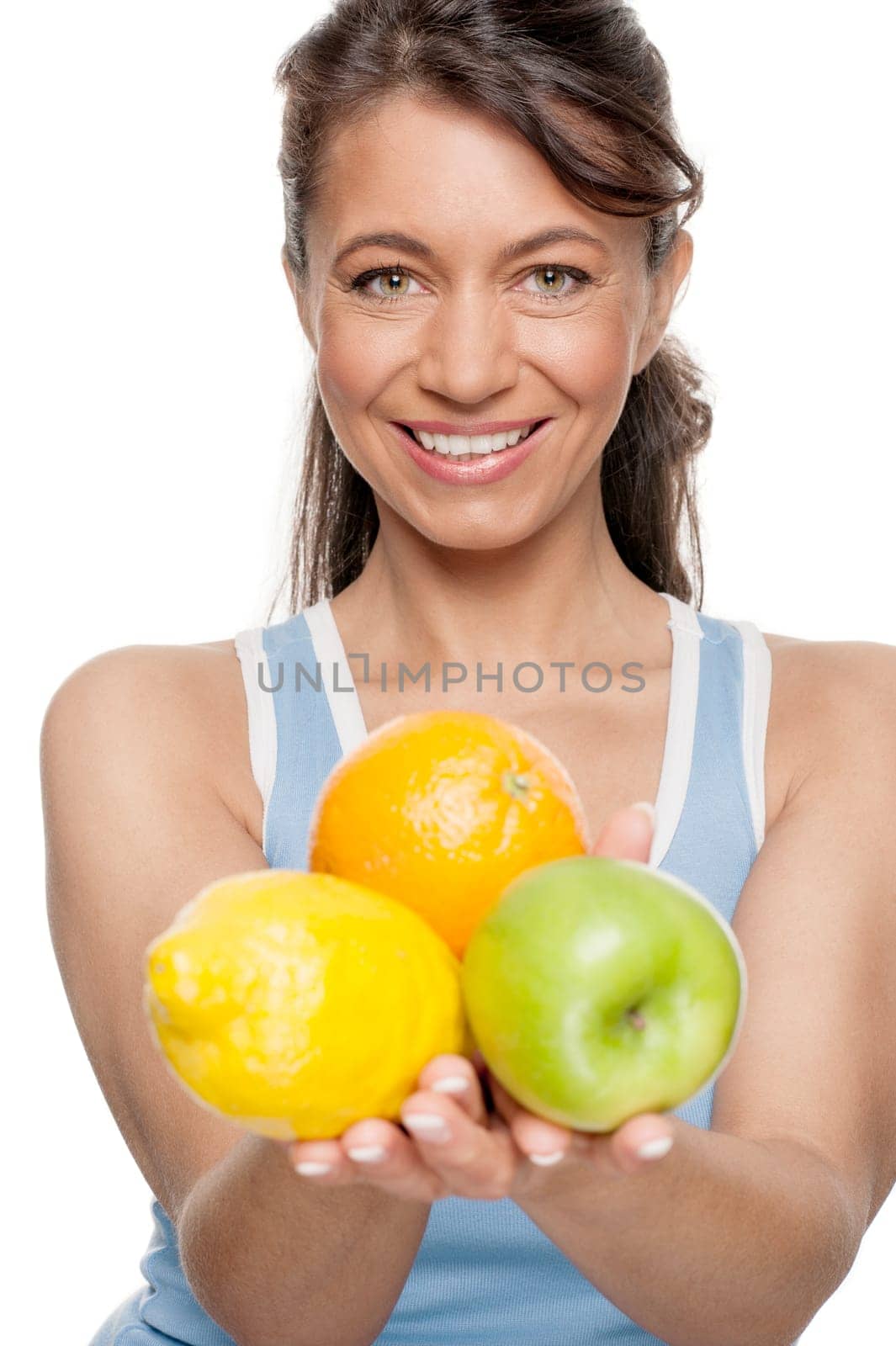 Smiling woman in front of white background with fruit