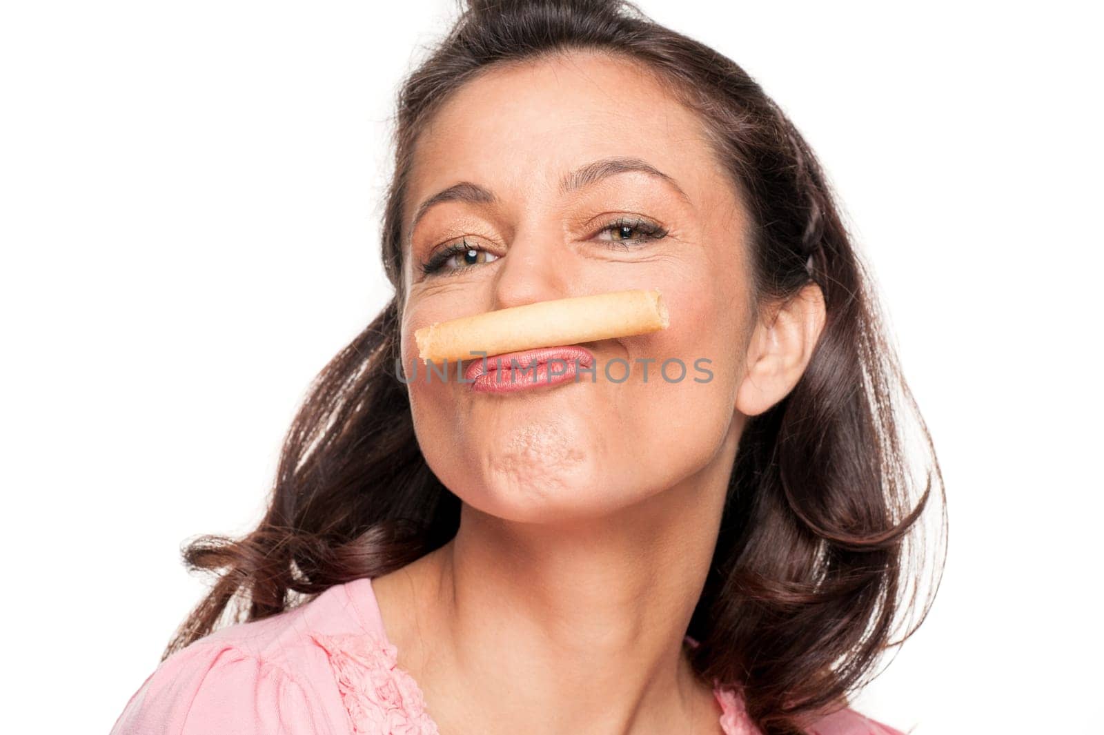 Smiling woman with a biscuit against a white background