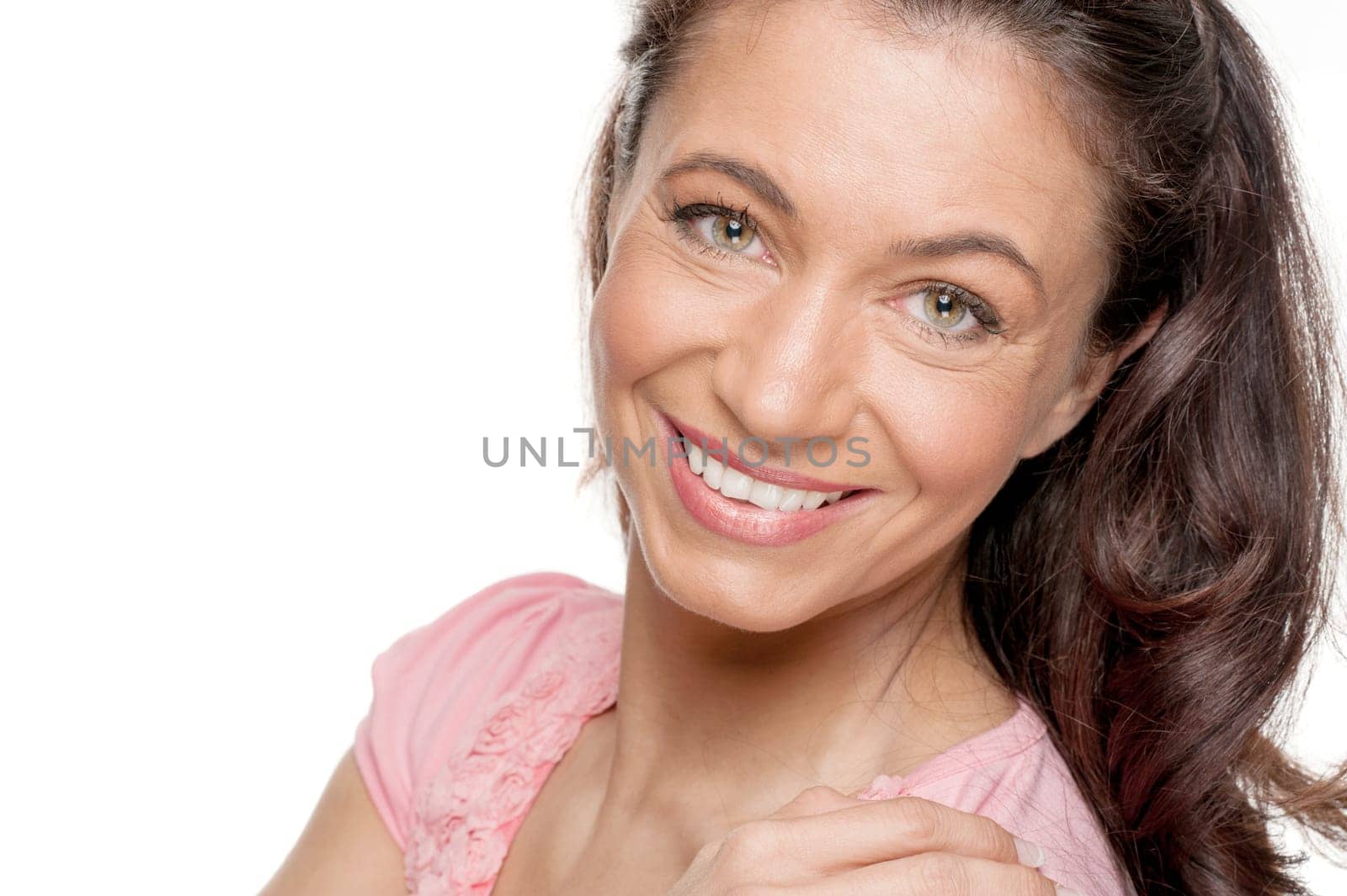 Young and smiling woman in front of white background