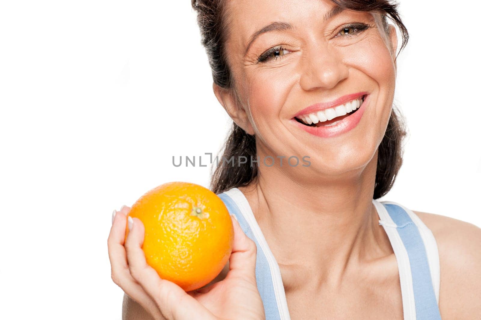 Smiling woman in front of white background with an orange